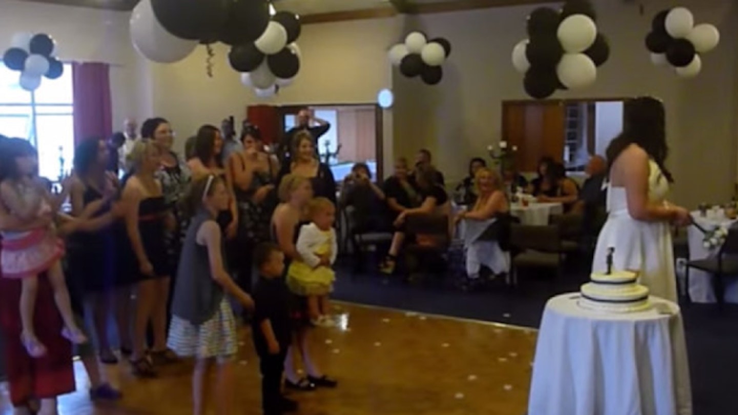 VIDEO: Excitable mother DROPS baby trying to catch bouquet at wedding