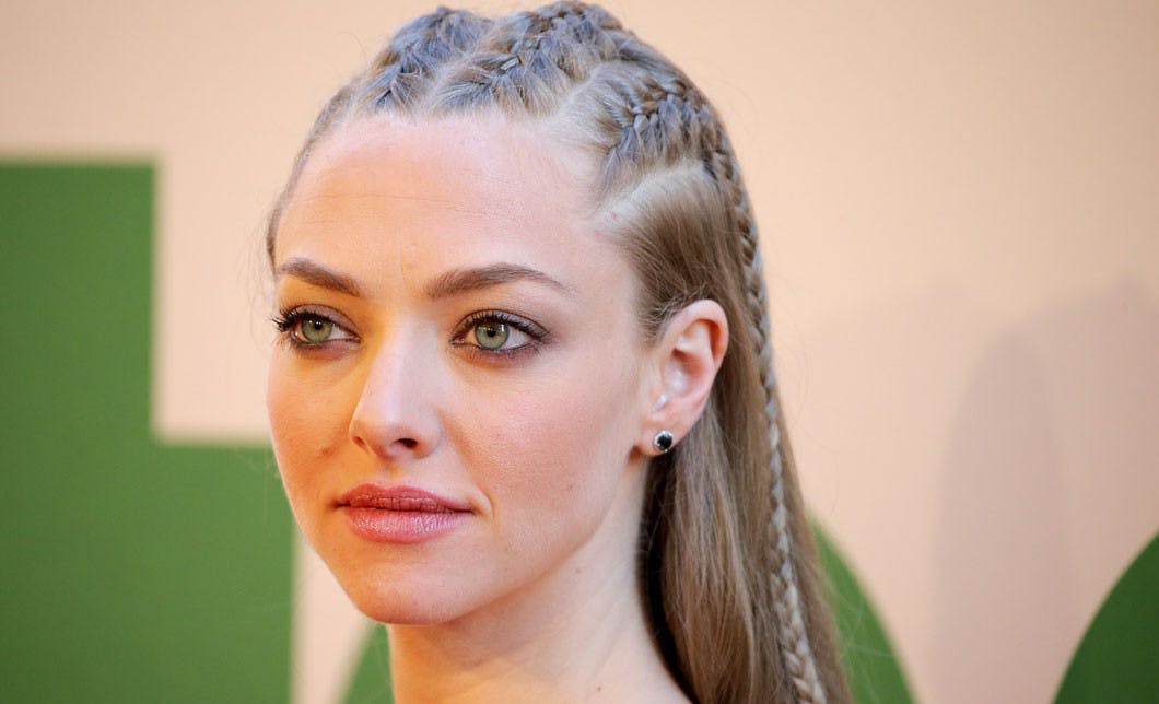 Amanda Seyfried's hair pulled over one shoulder in a loose fat braid