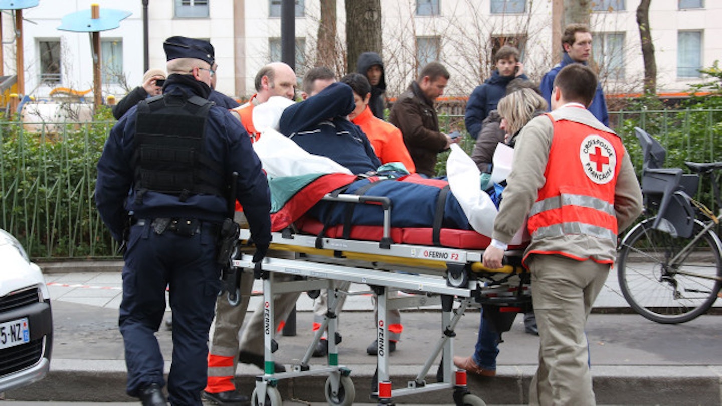An injured person is taken away from the scene of the shootings on Wednesday