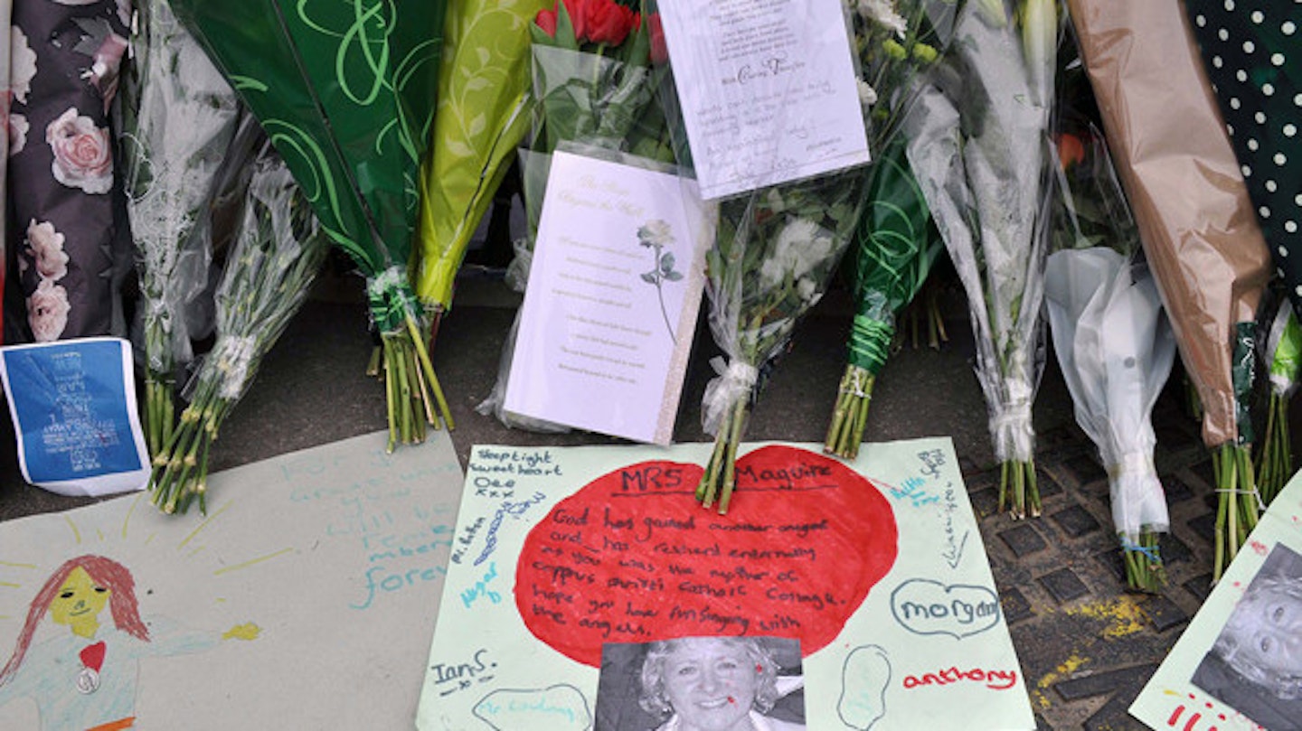 Flowers still surround Ann Maguire's school