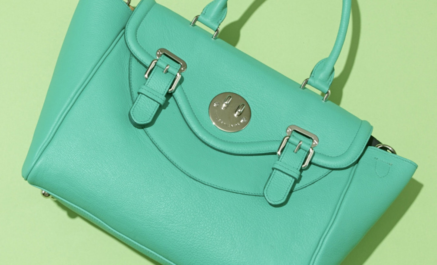 green leather handbag