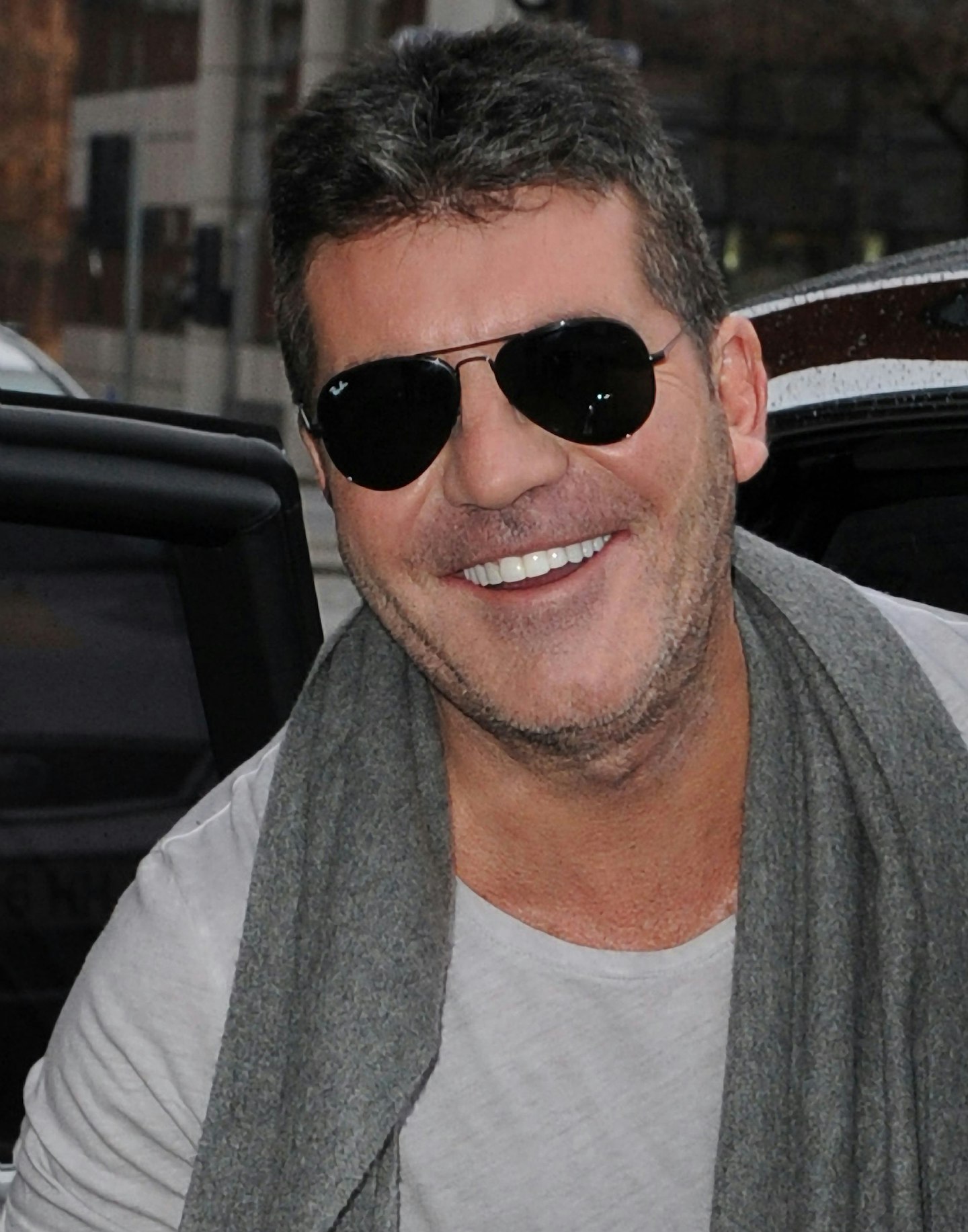 simon-cowell-sunglasses-laughing-grey-shirt