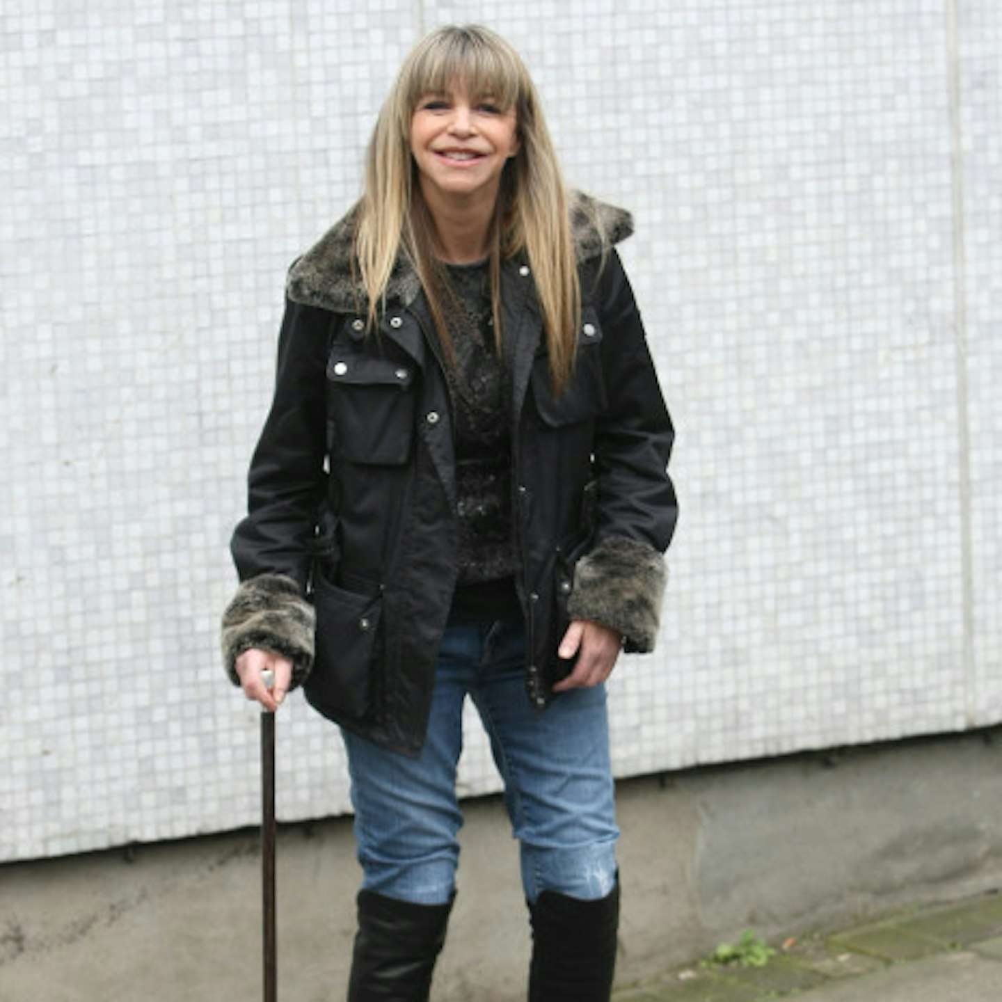 Leslie in 2011, with blonde hair and walking with the aid of a stick