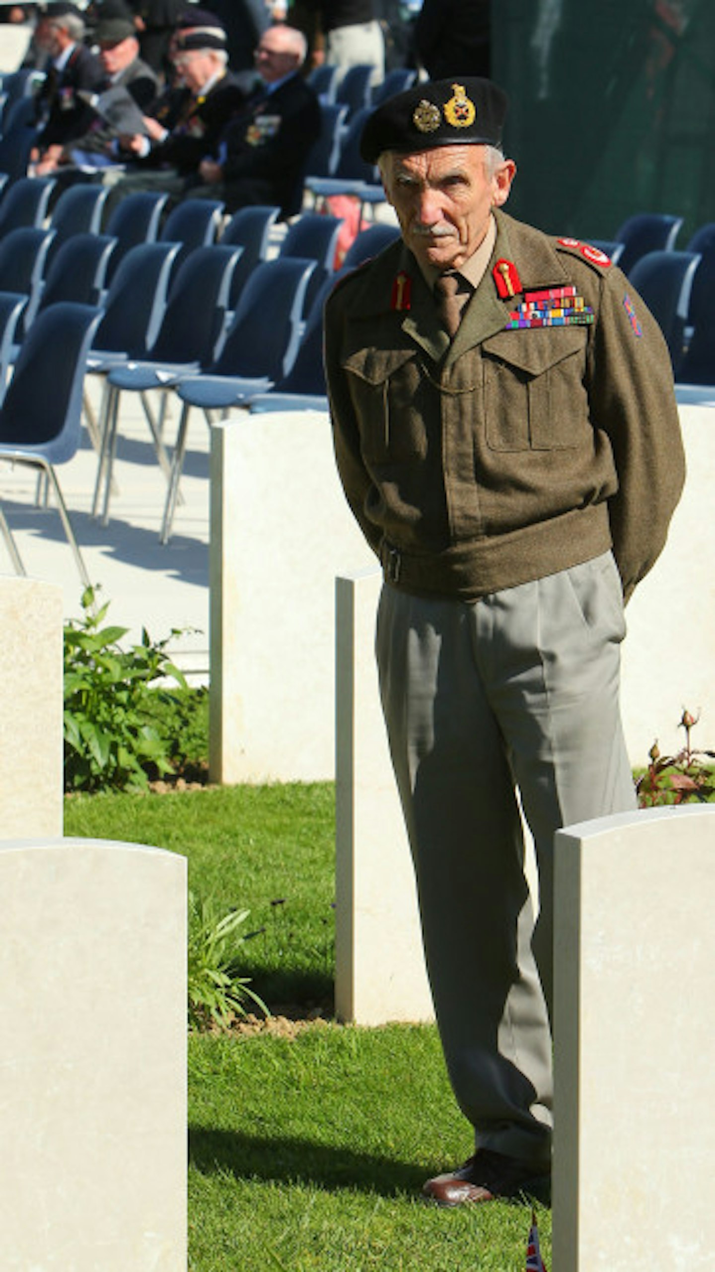 A war veteran reflects in the cemetary on the 70th Anniversary of the landings.