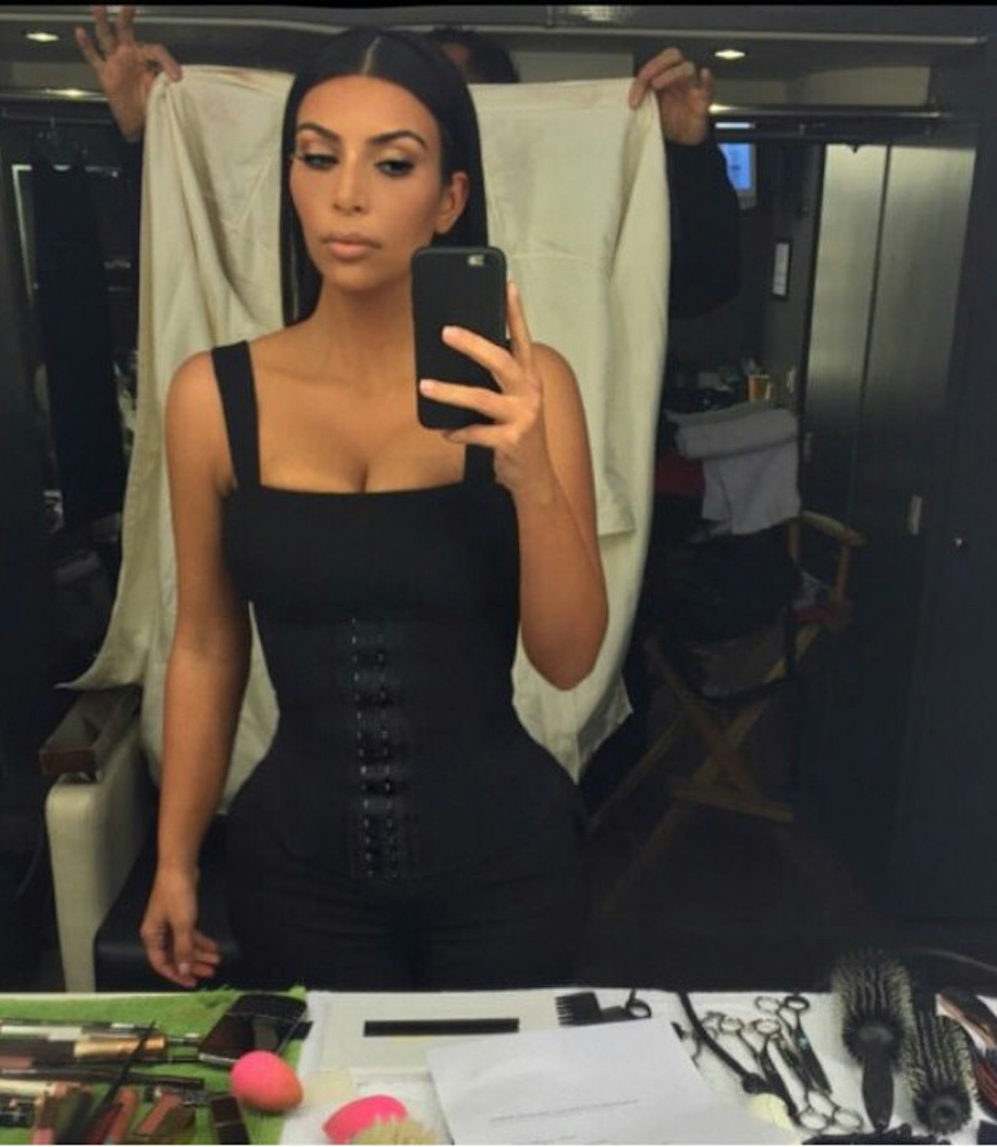 Kim Kardashian brings in a BACKDROP FLUNKEY to show off her tiny