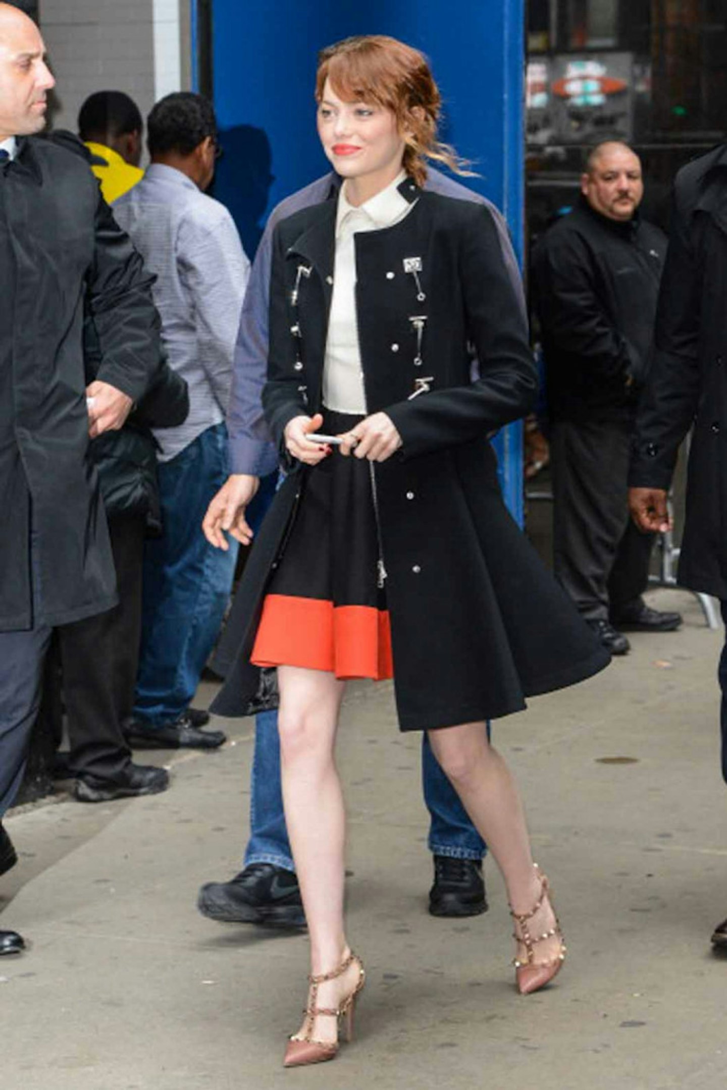 Emma Stone style black long coat orange skirt