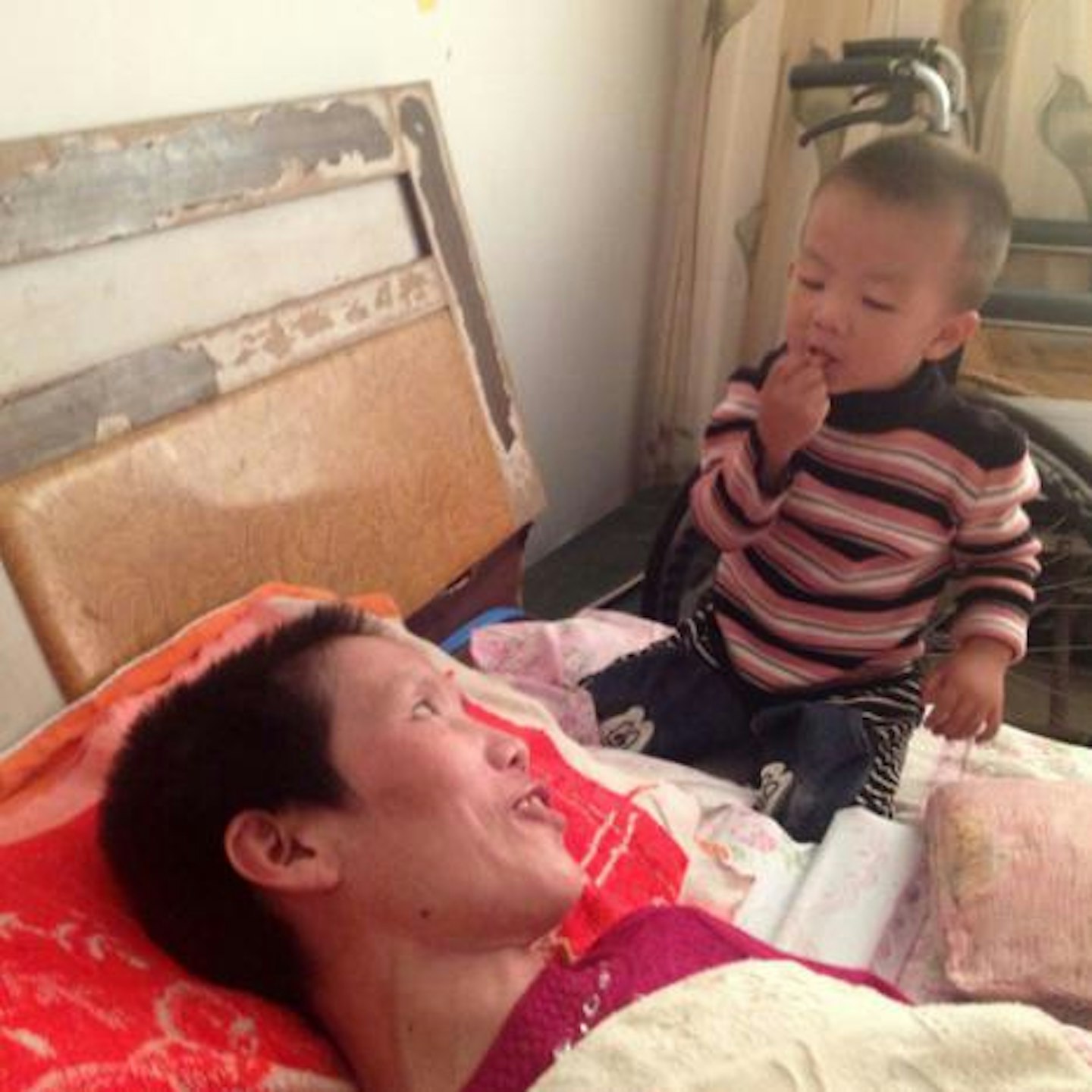Gao Qianbo feeding his mother Zhang Rongxiang in Shuyang city, Jiangsu province, China