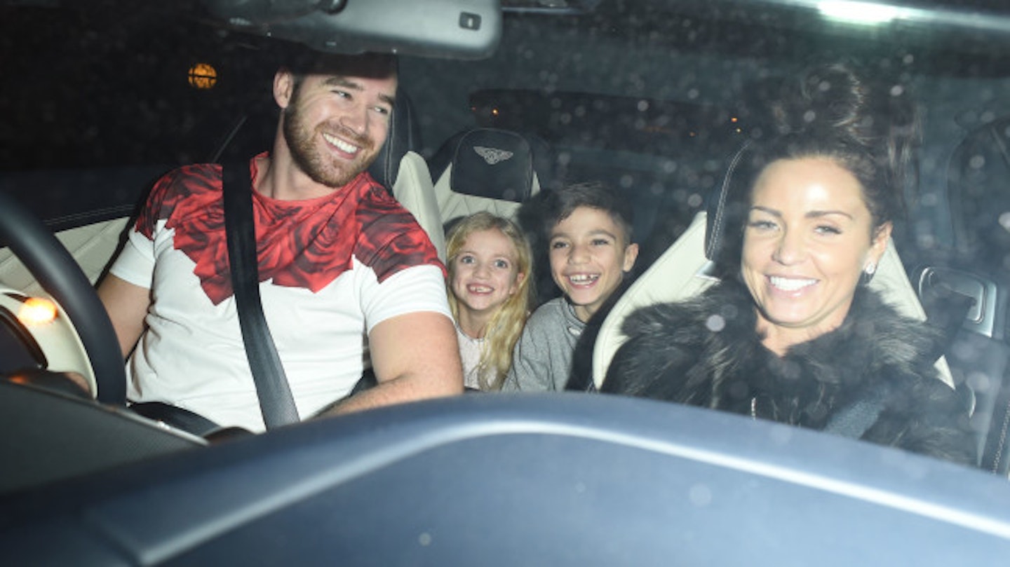 Katie leaving Sam's concert with hubby Kieran and Junior and Princess