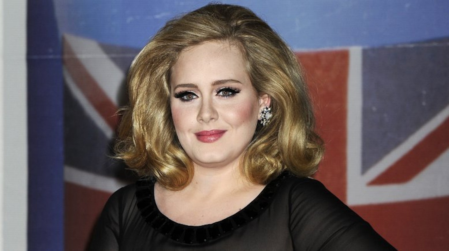Adele in front of a British flag