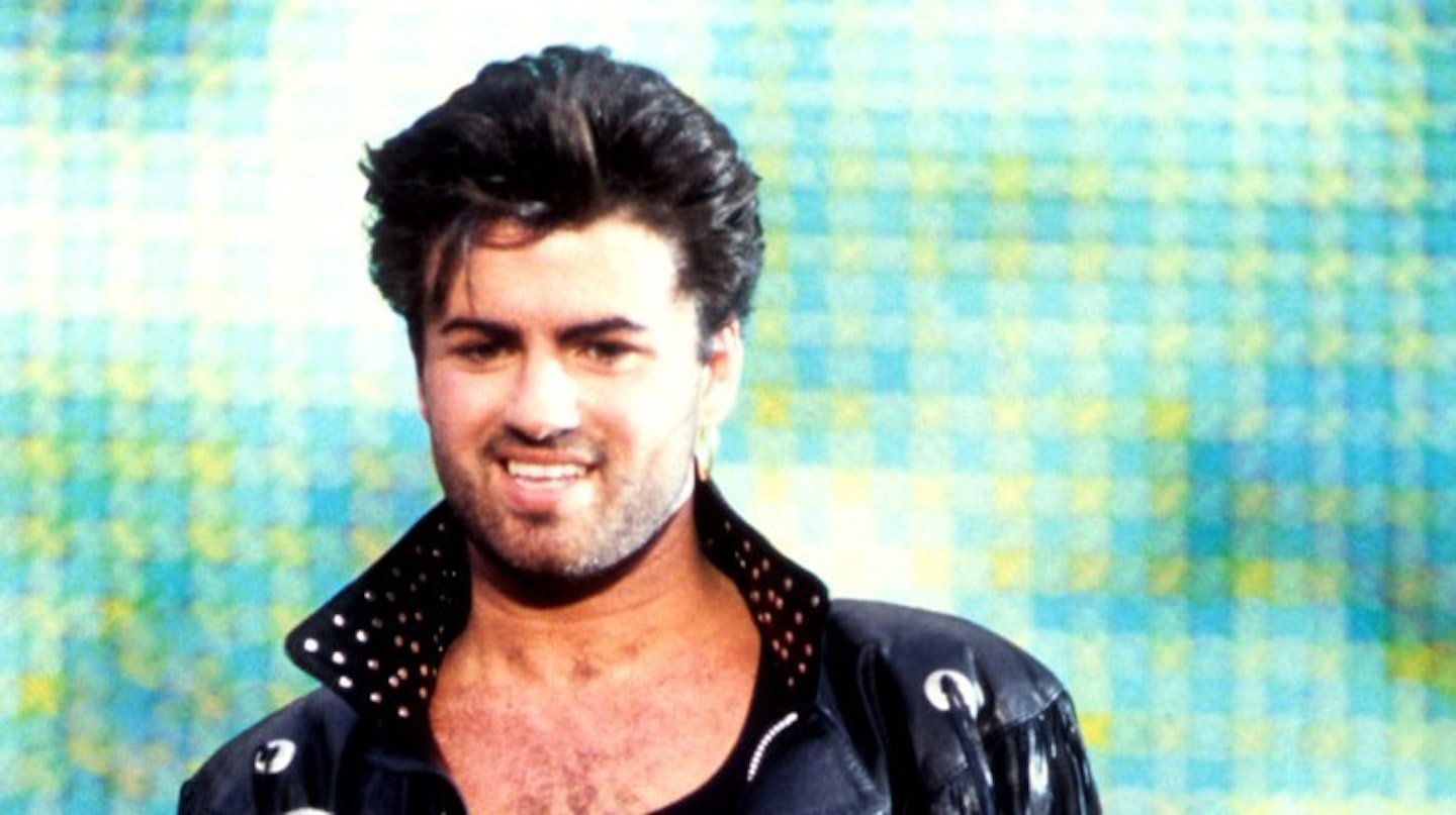 George Michael poses in a leather jacket