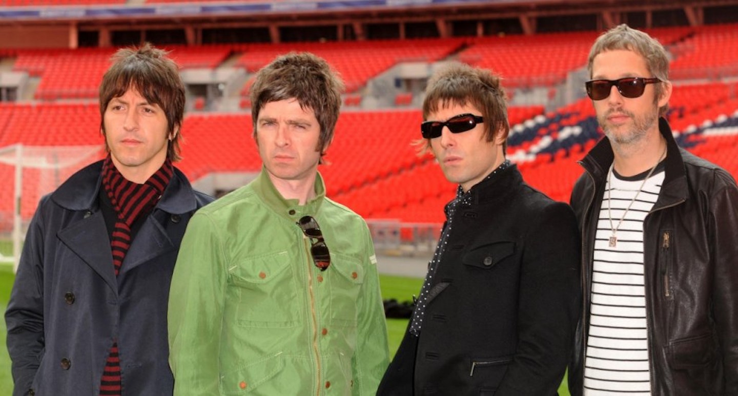 Oasis pose, two band members wear sunglasses