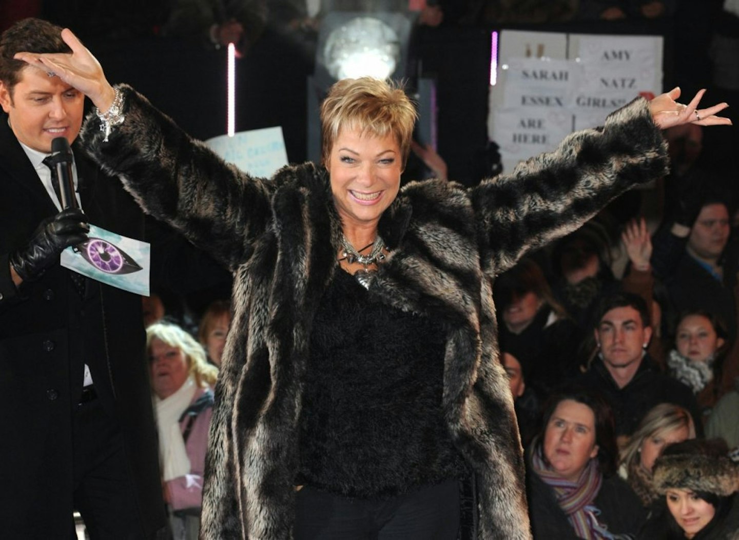 Denise Welch standing with her arms in the air