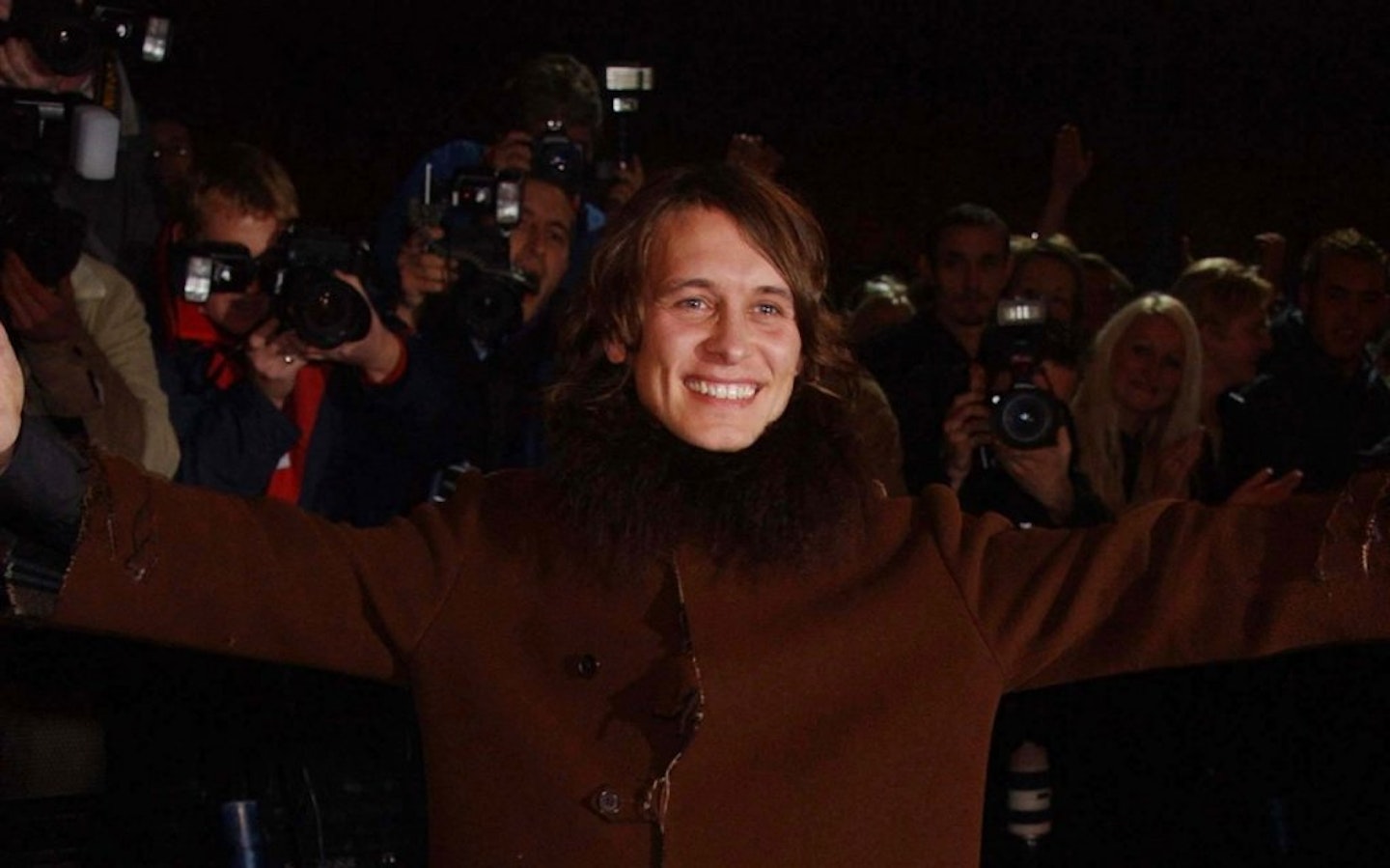 Mark Owen with arms in the air