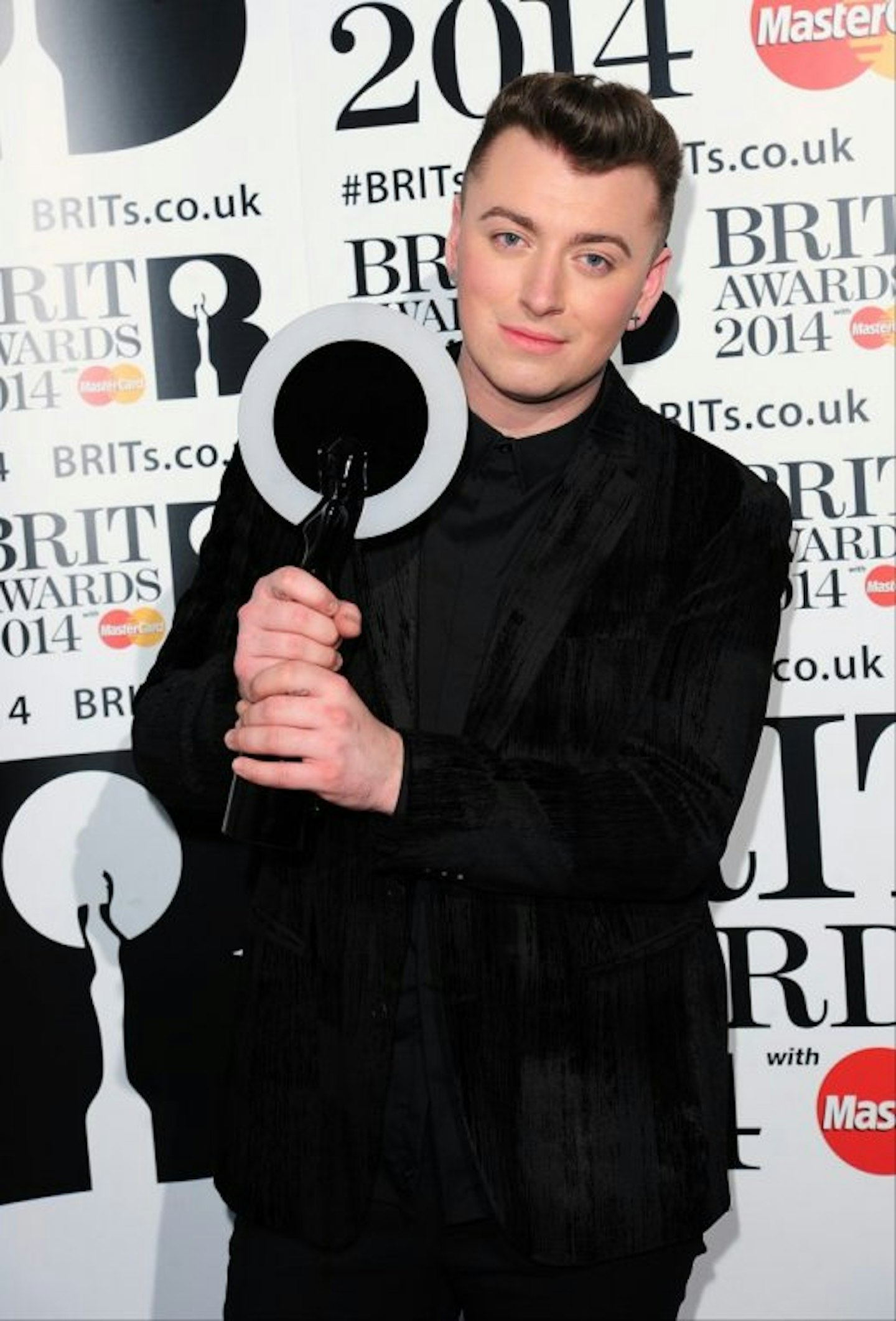 Sam Smith holding his BRIT Award