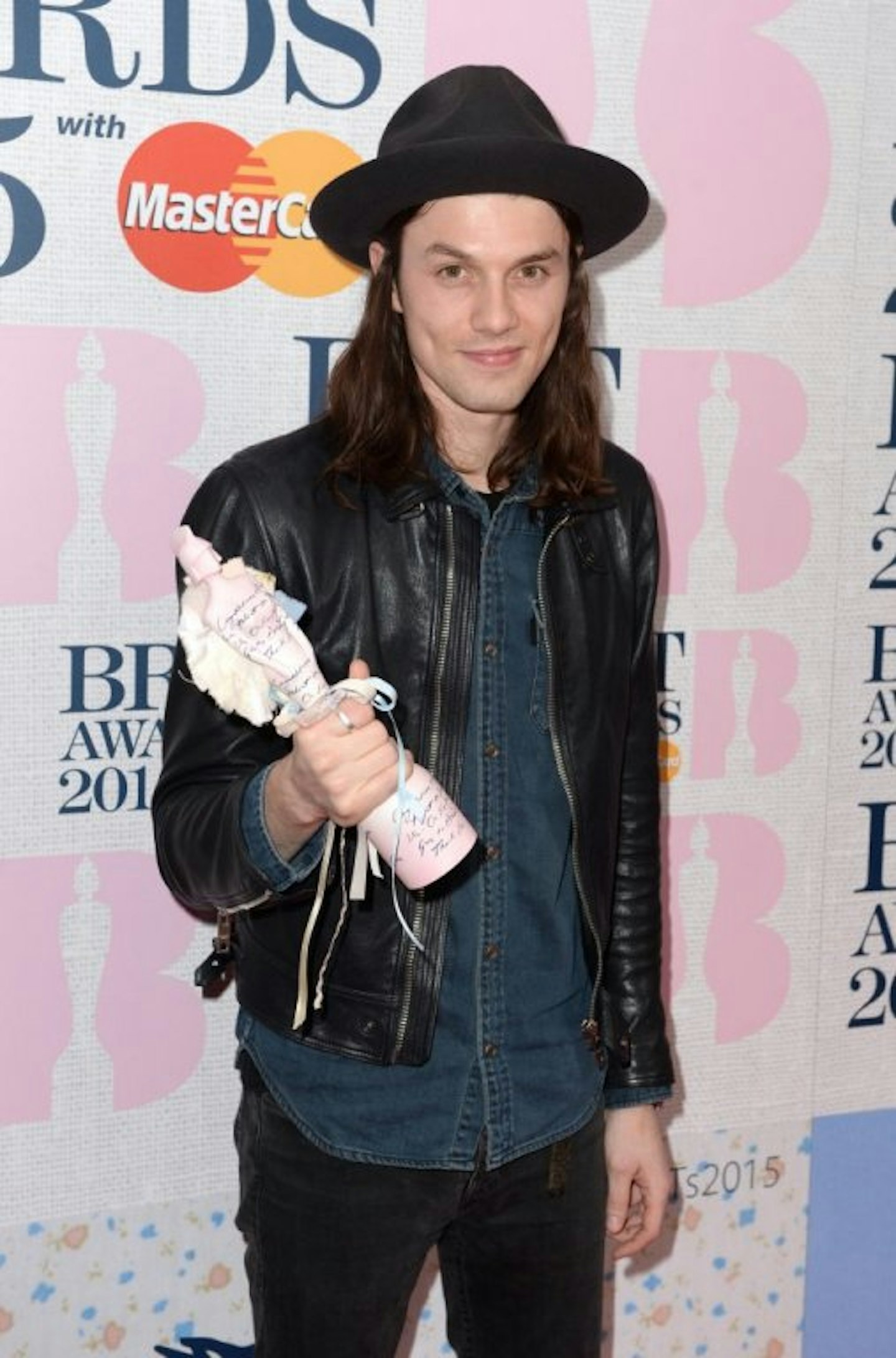 James Bay wearing a hat and holding BRIT Award
