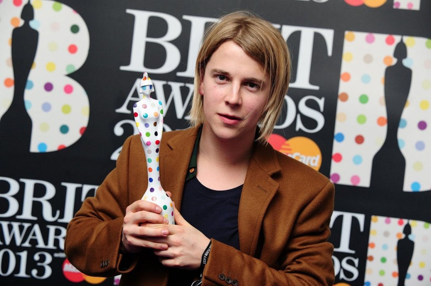 Tom Odell holding BRIT Award