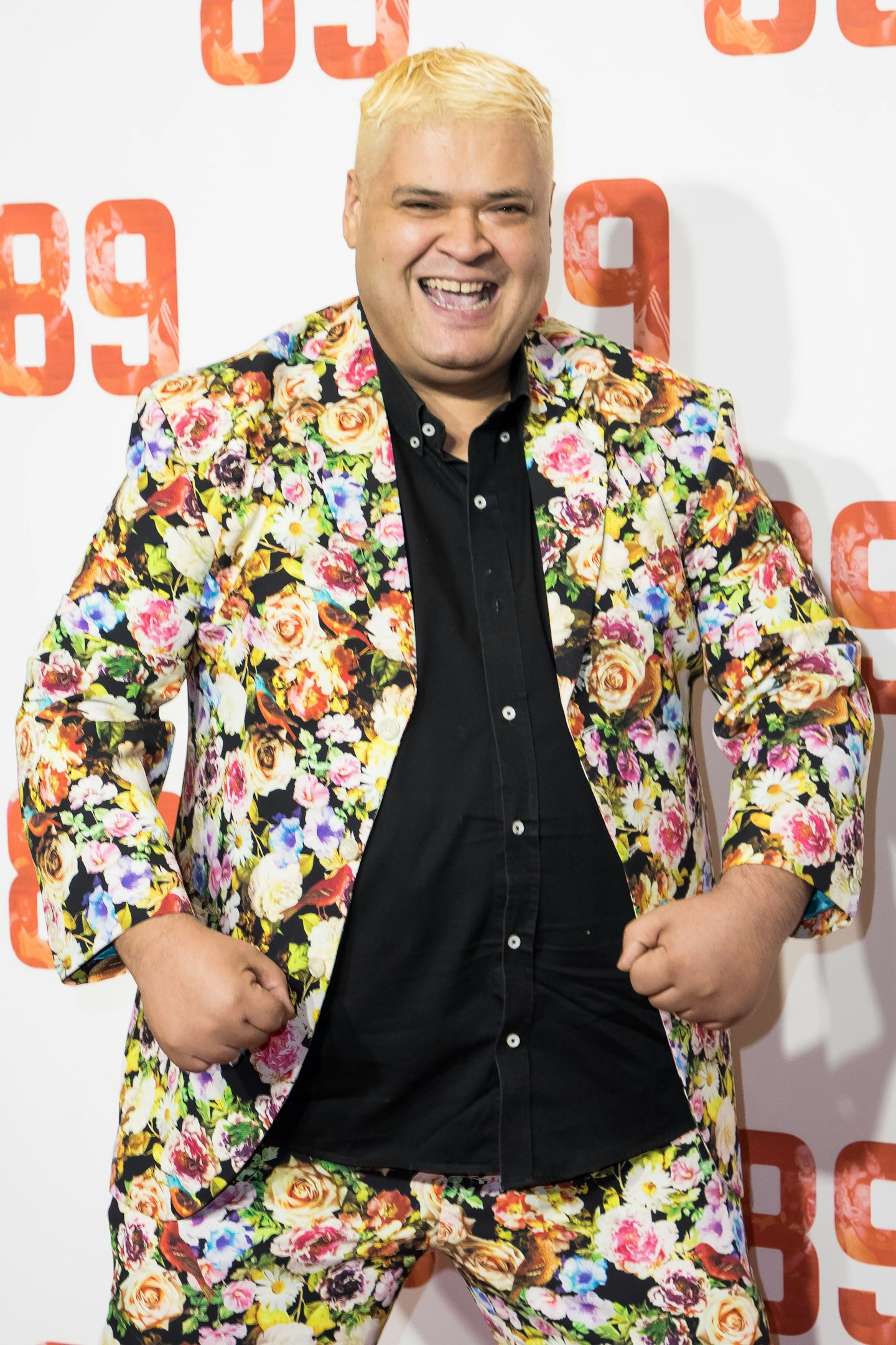 Heavy D posing in a flowery suit 