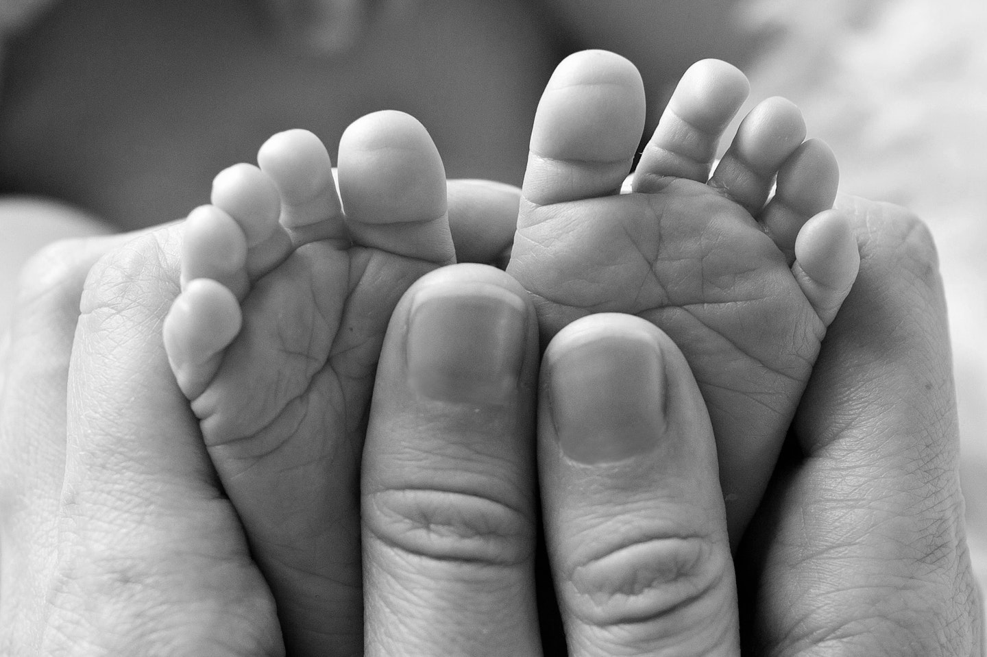 Black and white photo of baby tiny feet