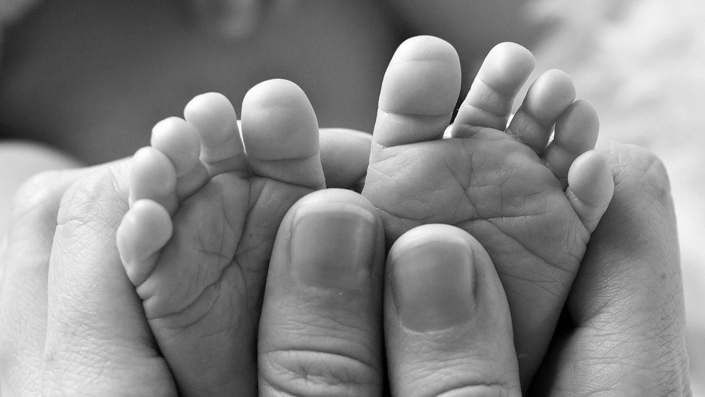 Black and white photo of baby tiny feet