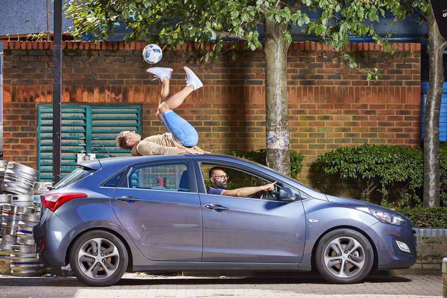 Longest time controlling a football with the soles whilst on the roof of a moving car