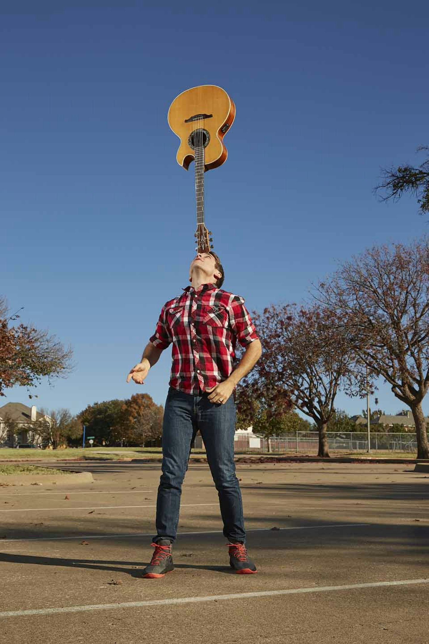 Longest duration balancing a guitar on the forehead