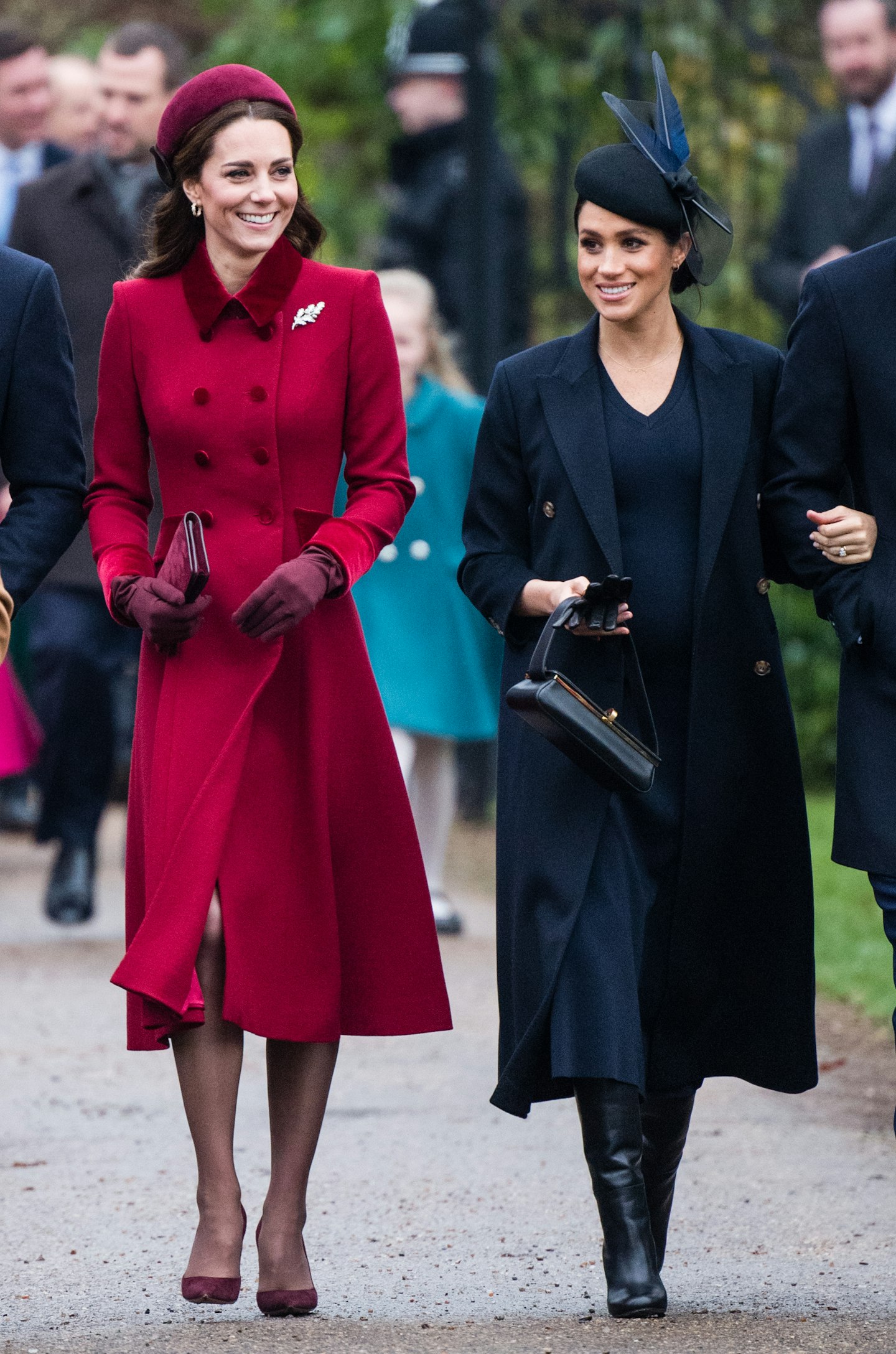Meghan Markle opted for darker shades at the Christmas church service, while Kate stood out in berry shades