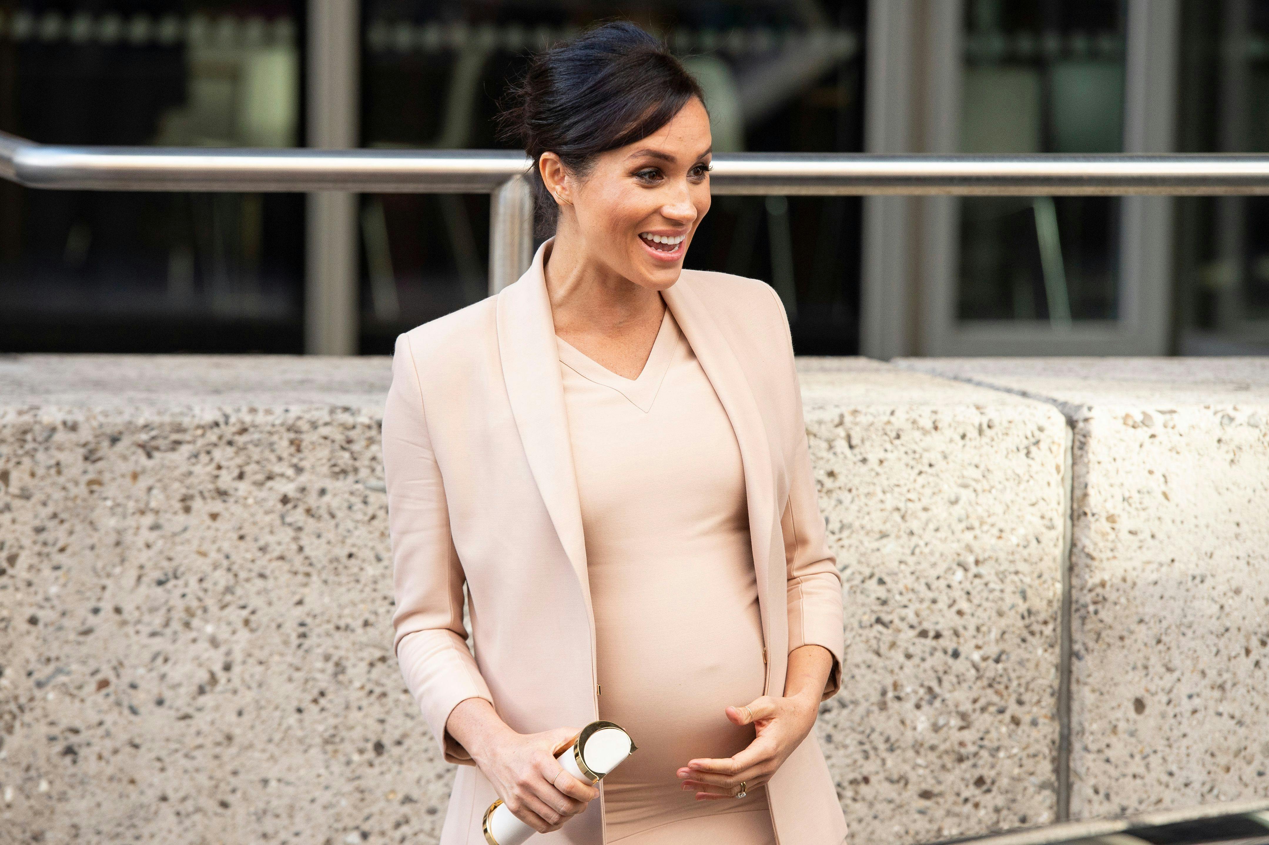 Is This Why Meghan Markle Keeps Holding Her Baby Bump?