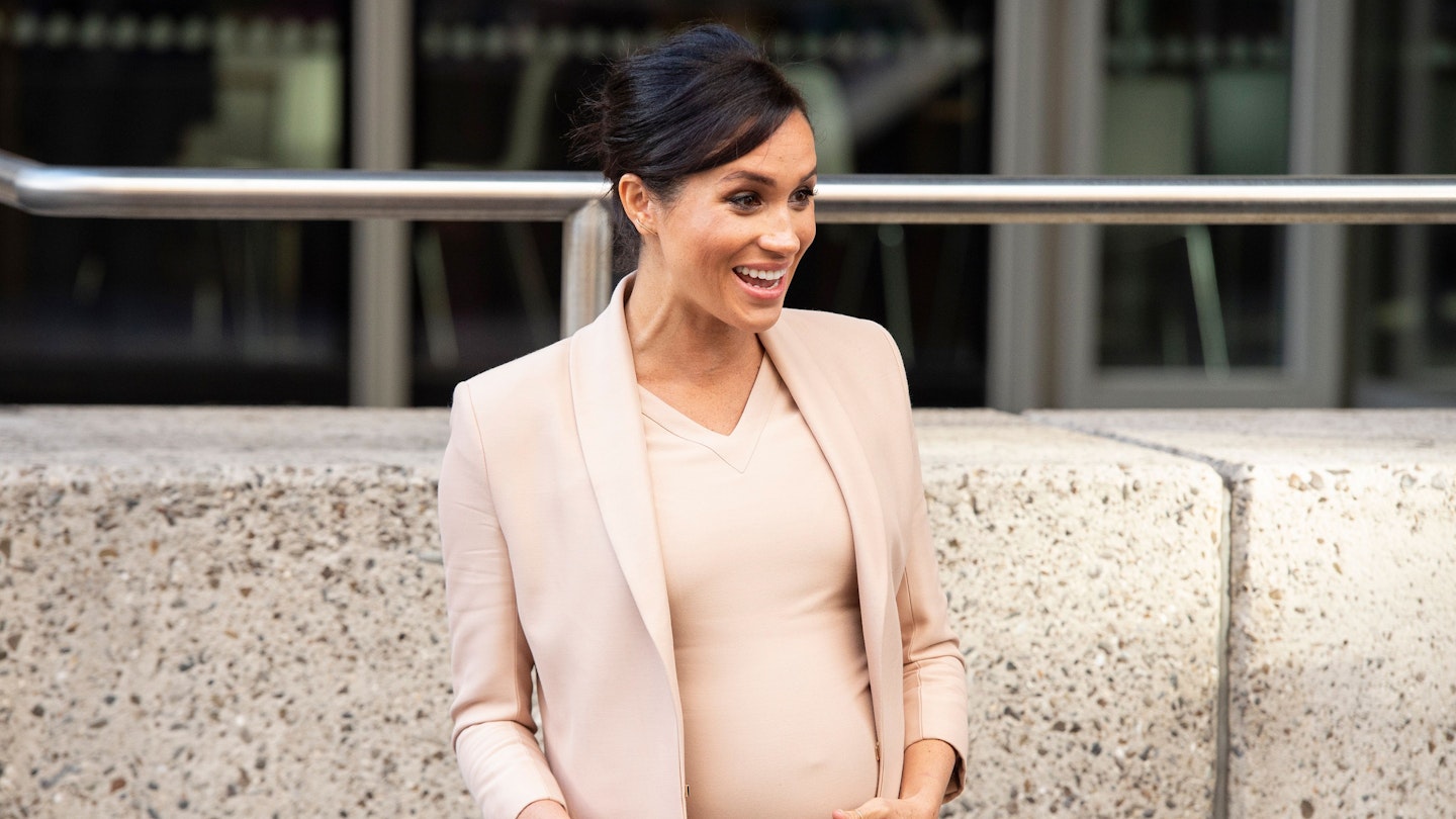 Is This Why Meghan Markle Keeps Holding Her Baby Bump?