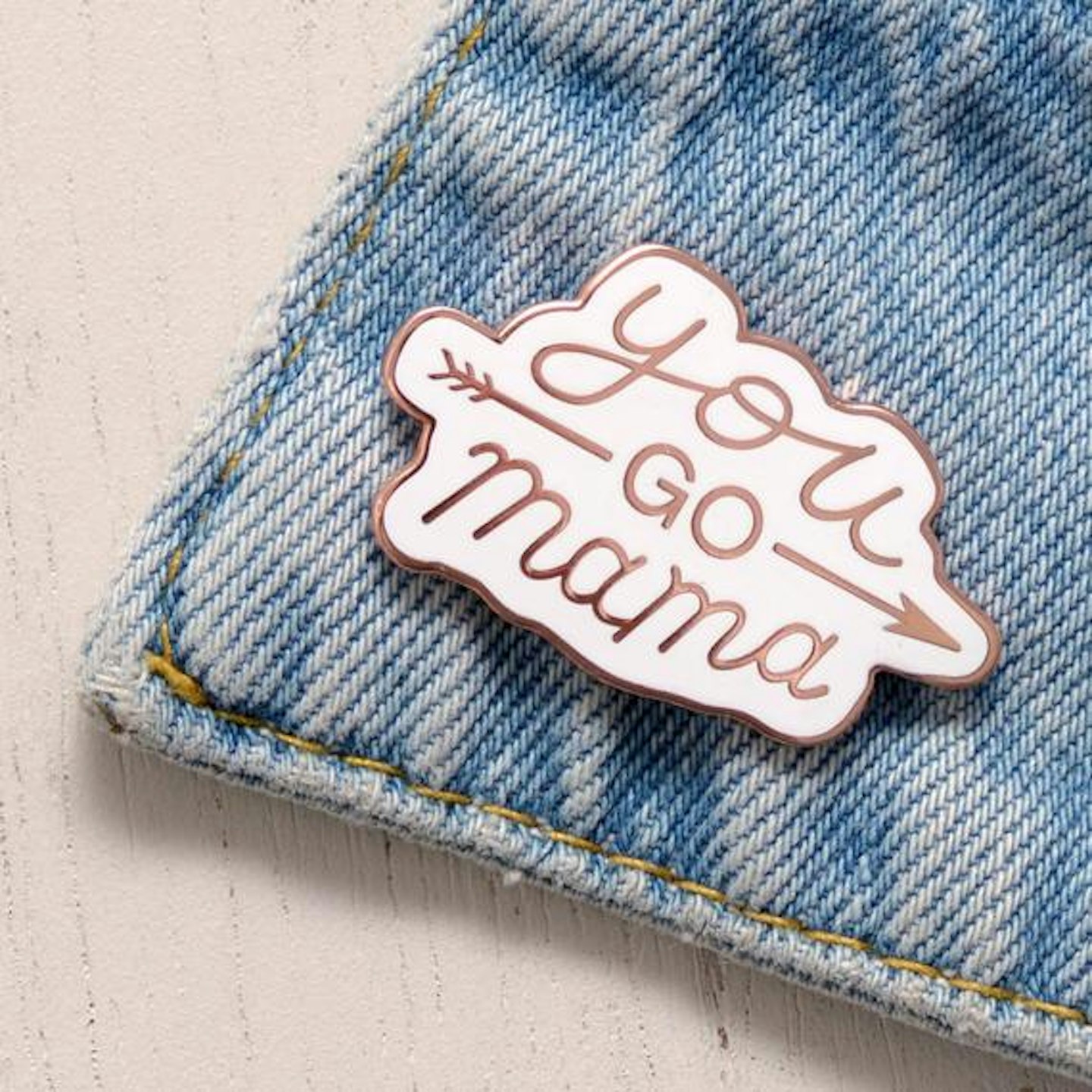 Slogan pin on denim jacket