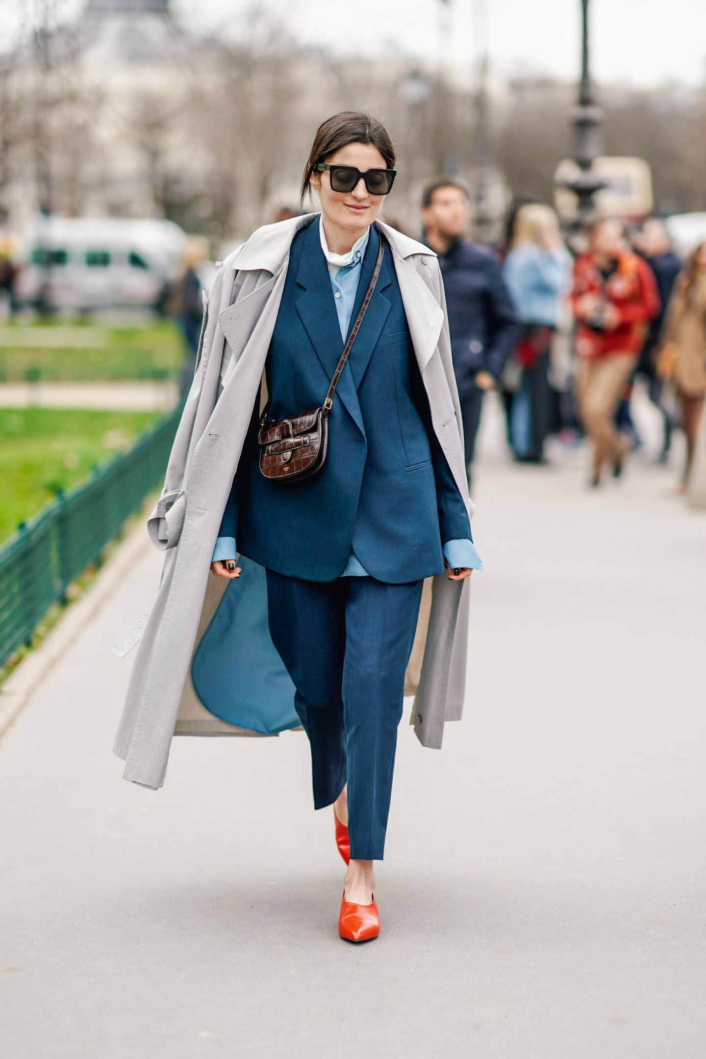 Trench coat layered over suit street style
