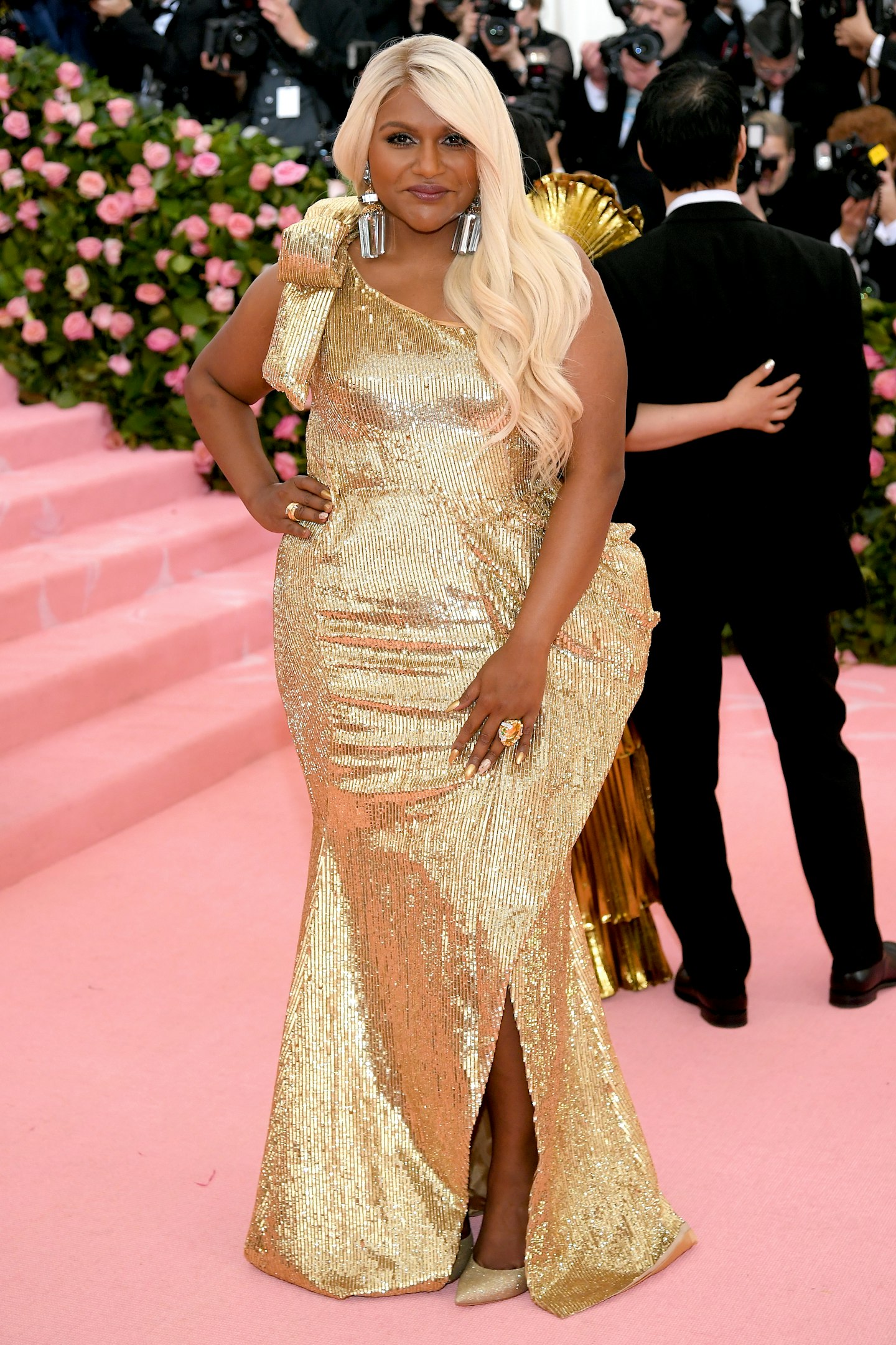 Mindy Kaling wearing a gold Moschino dress