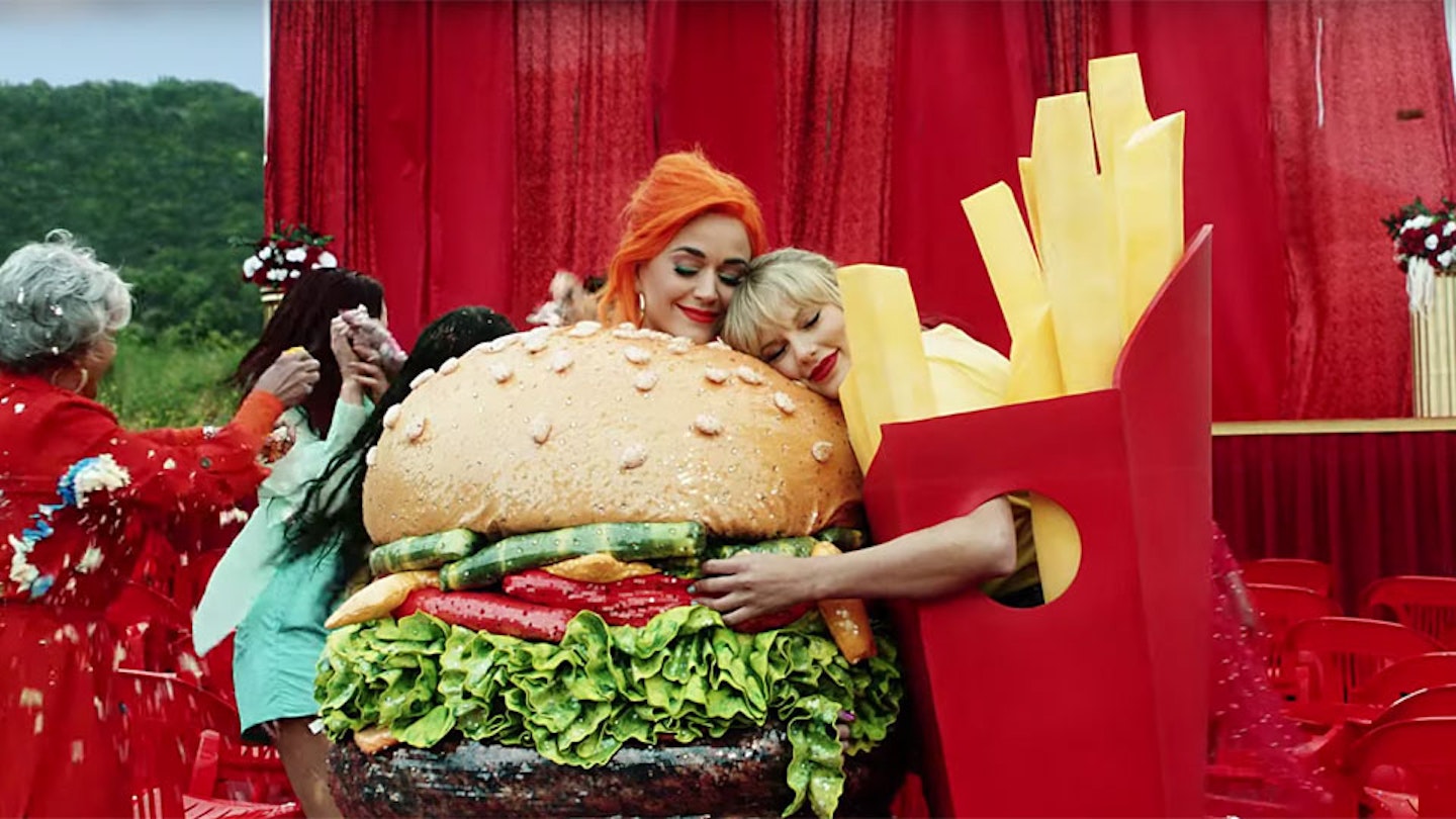 Katy Perry and Taylor Swift dressed as a burger and fries hugging
