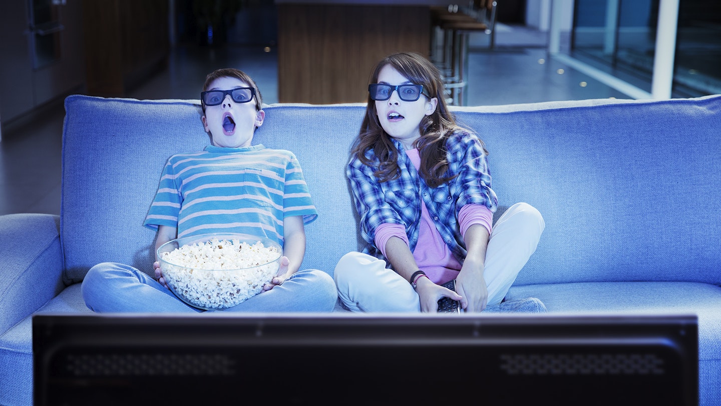 Children watching home cinema movie popcorn