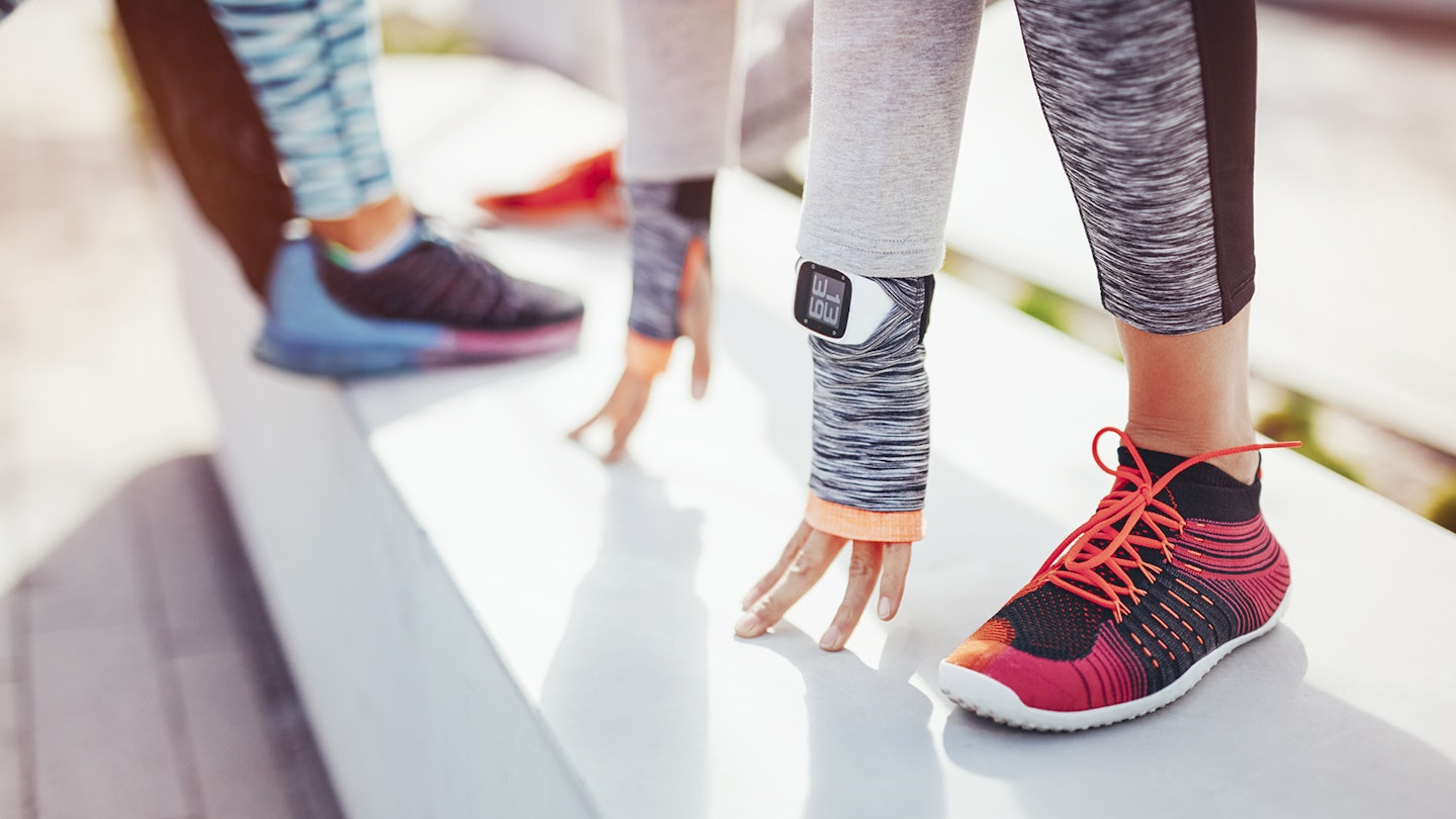 Women stretching fitness trackers