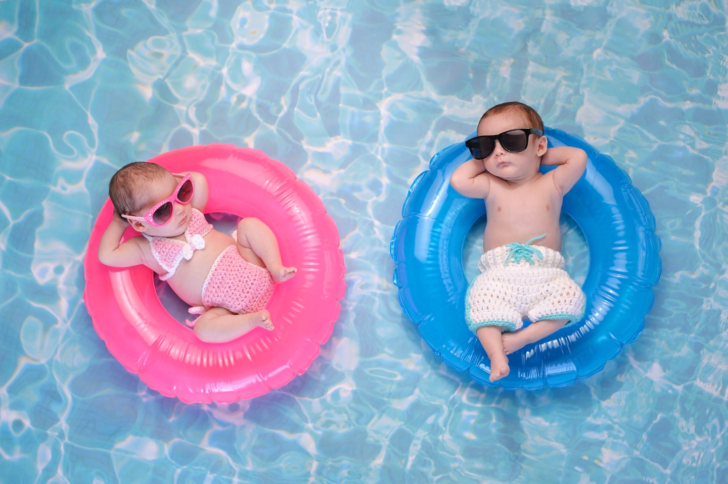 Babies floating in inflatables in a pool