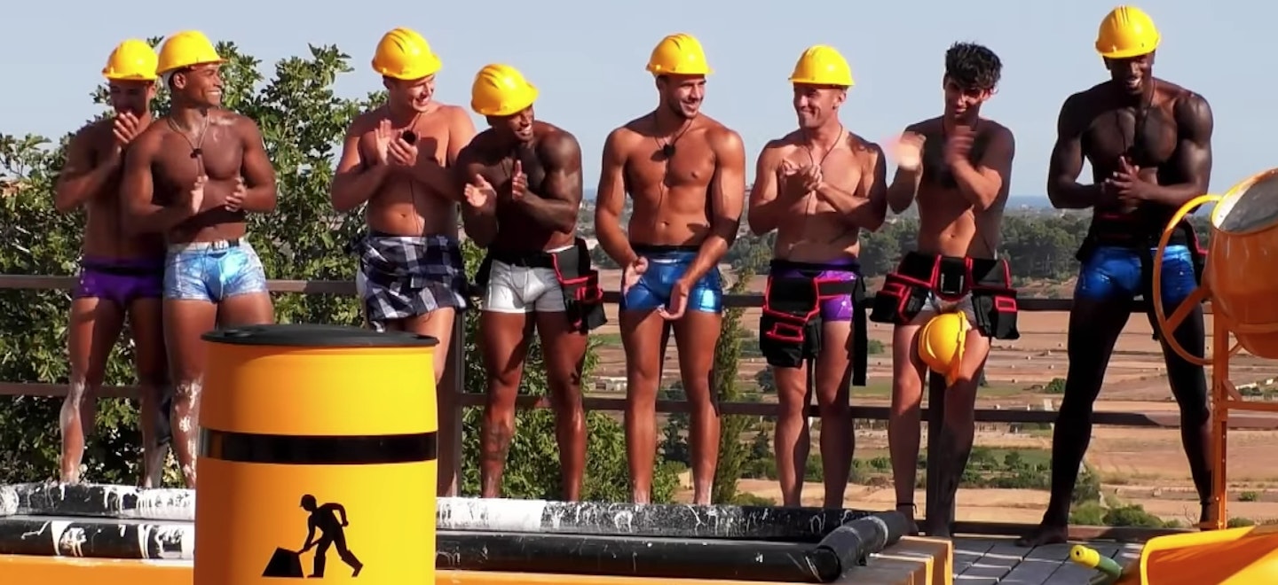 ovie from love island and the other boys wearing builders hats and sparkly shorts.