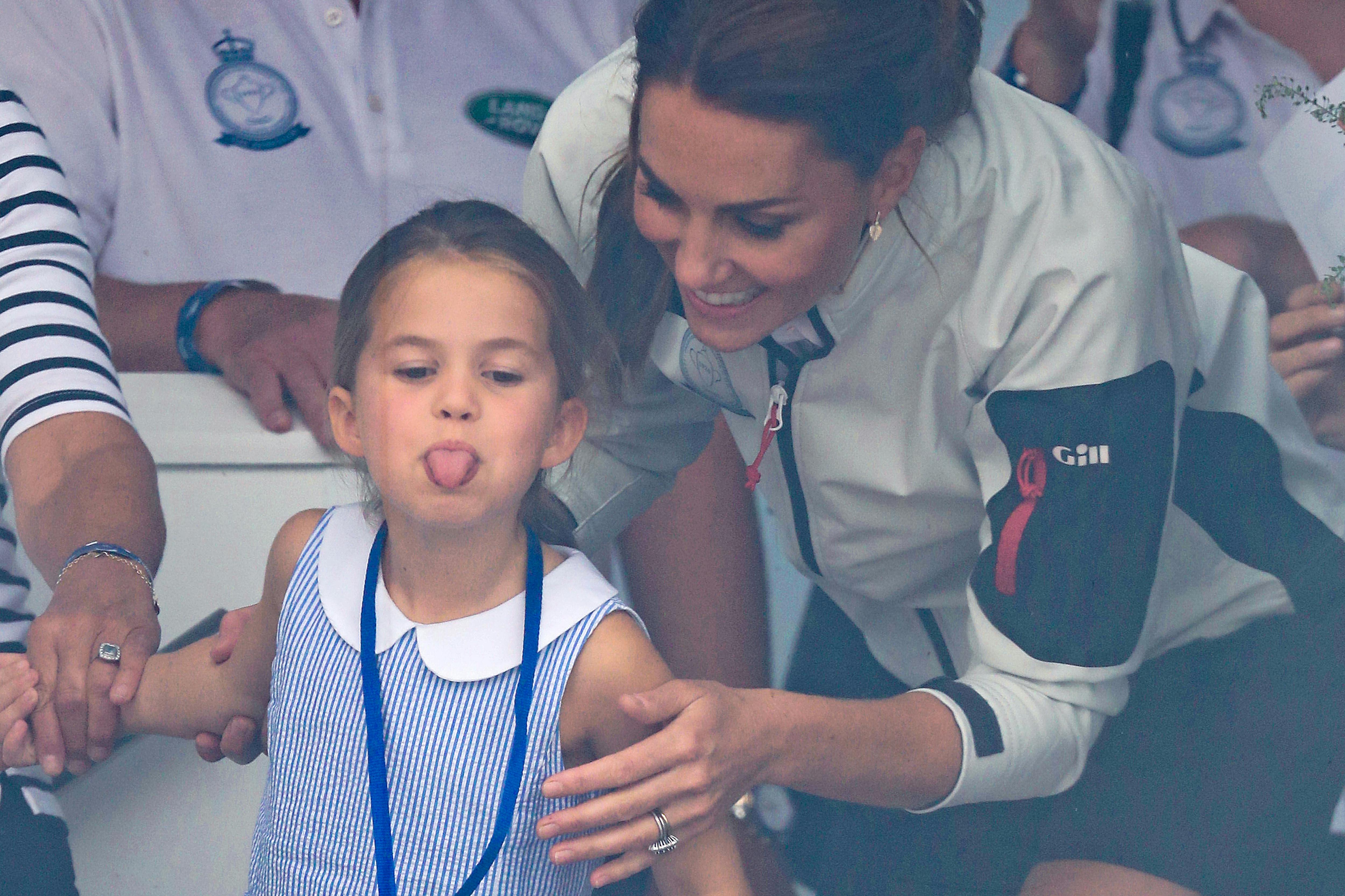 Princess Charlotte stuck her tongue out while wearing a gorgeous blue and  white dress.