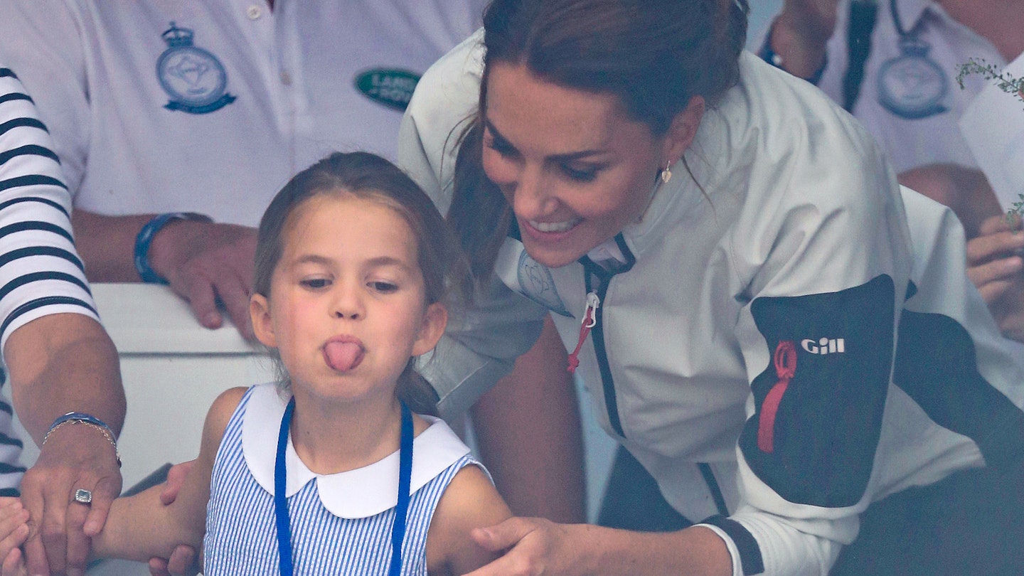 Princess Charlotte stuck her tongue out while wearing a gorgeous blue and white dress. Princess Charlotte stuck her tongue out while wearing a gorgeous blue and white dress.