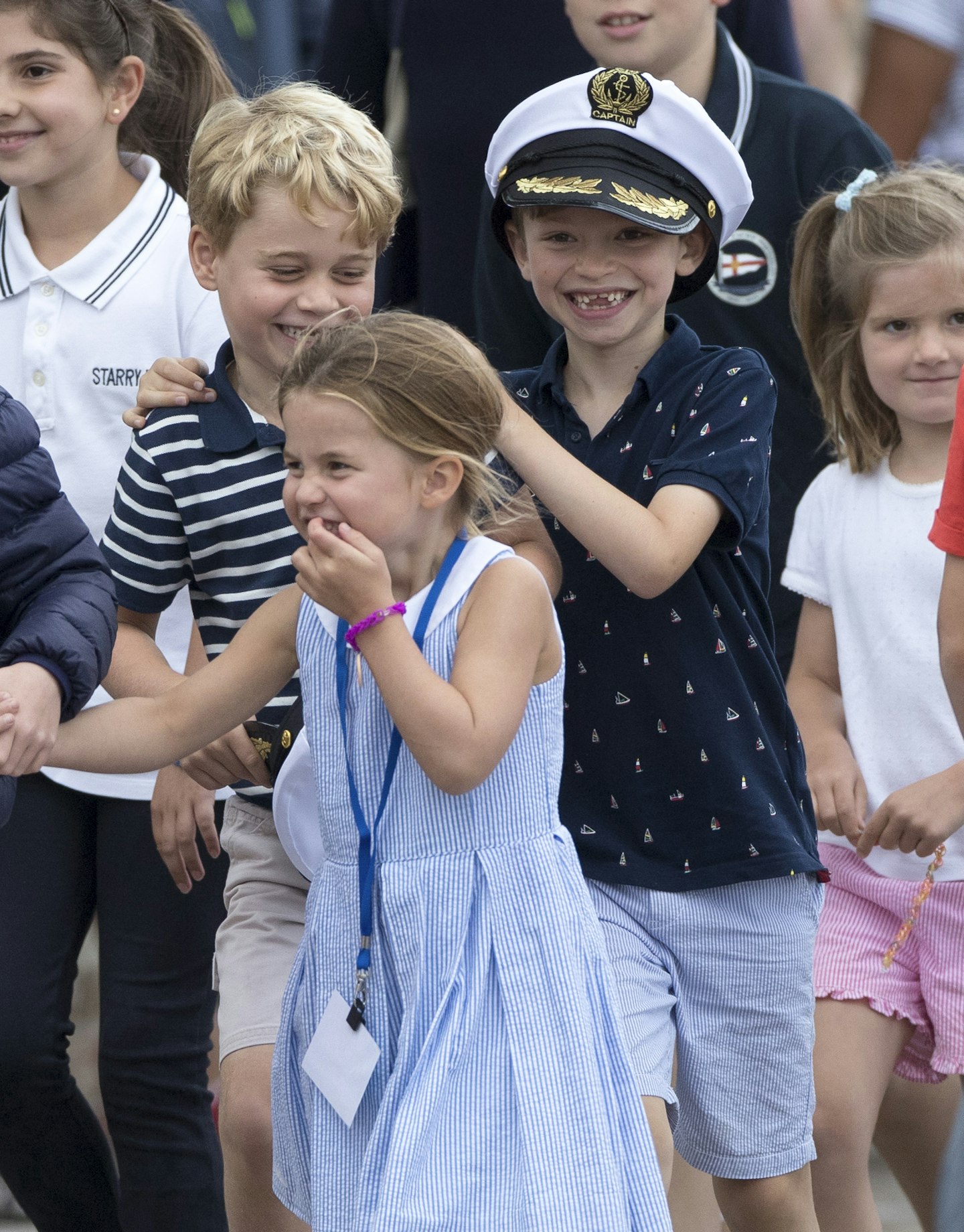 Princess Charlotte stuck her tongue out while wearing a gorgeous blue and white dress.