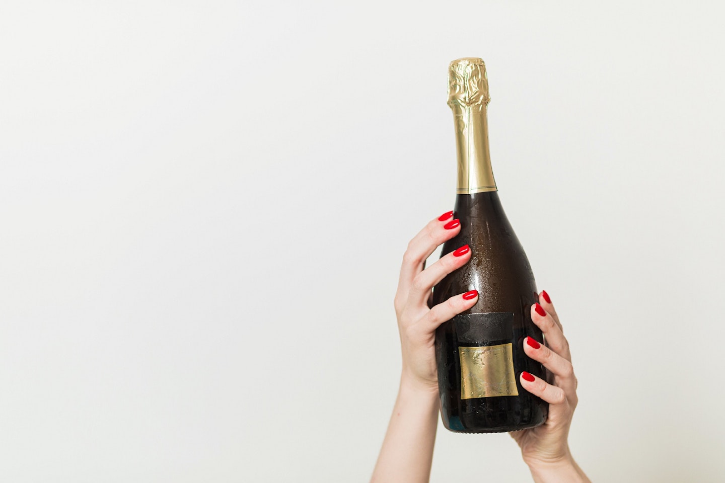 Hands holding up Prosecco bottle