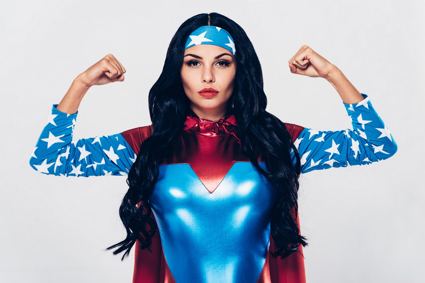 Woman in Super Woman costume in strong pose
