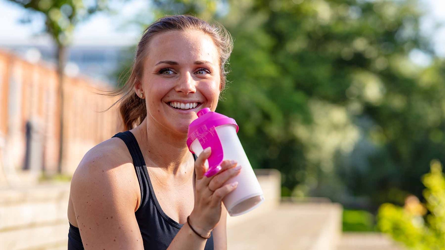 Woman drinking protein shake after workout