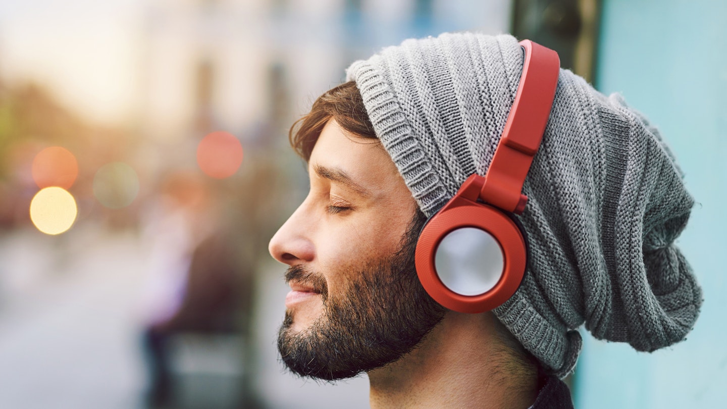 Man listening to Amazon Music HD on headphones which meet Sony LDAC wireless standards 