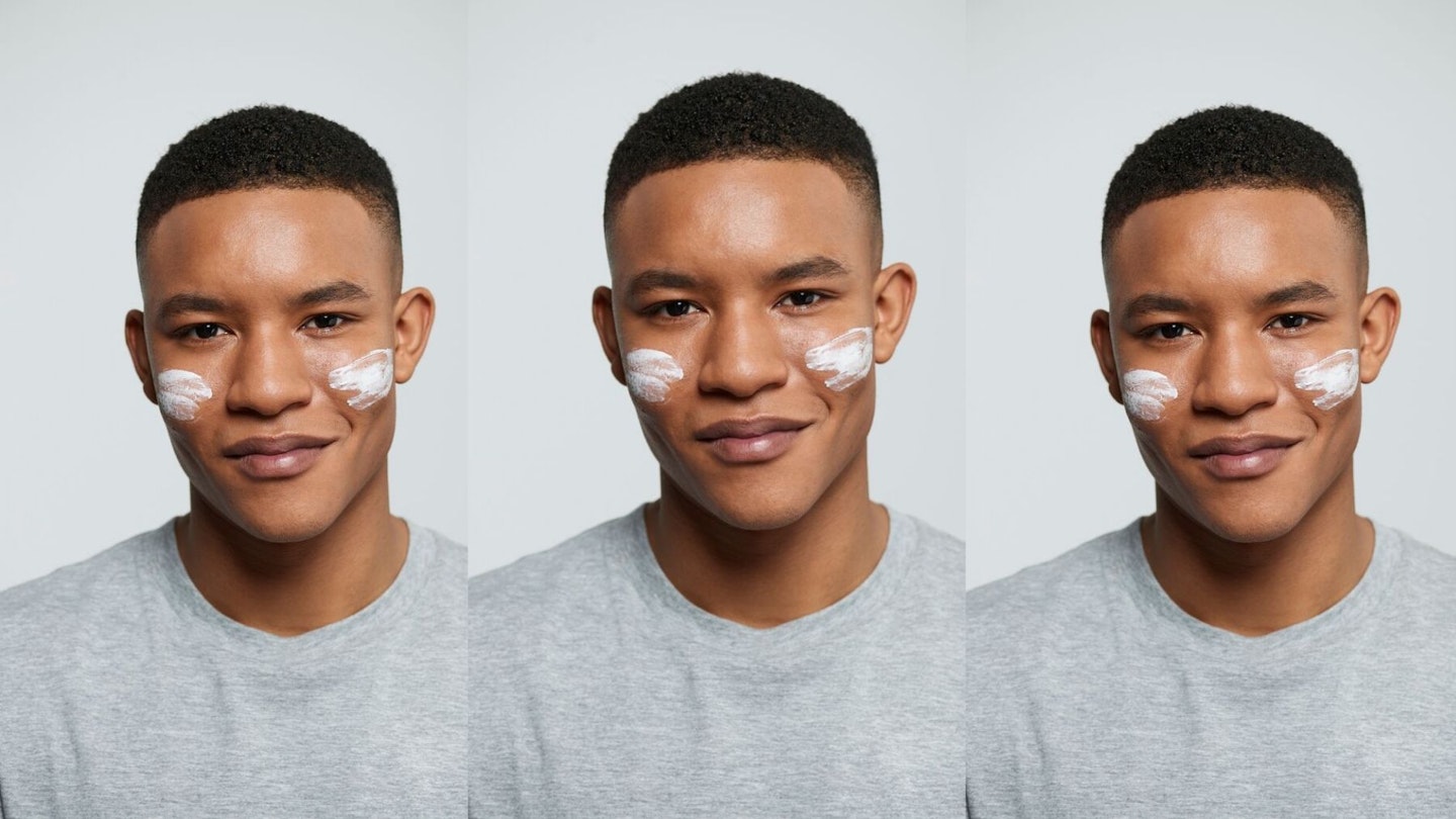 Young man with face cream on