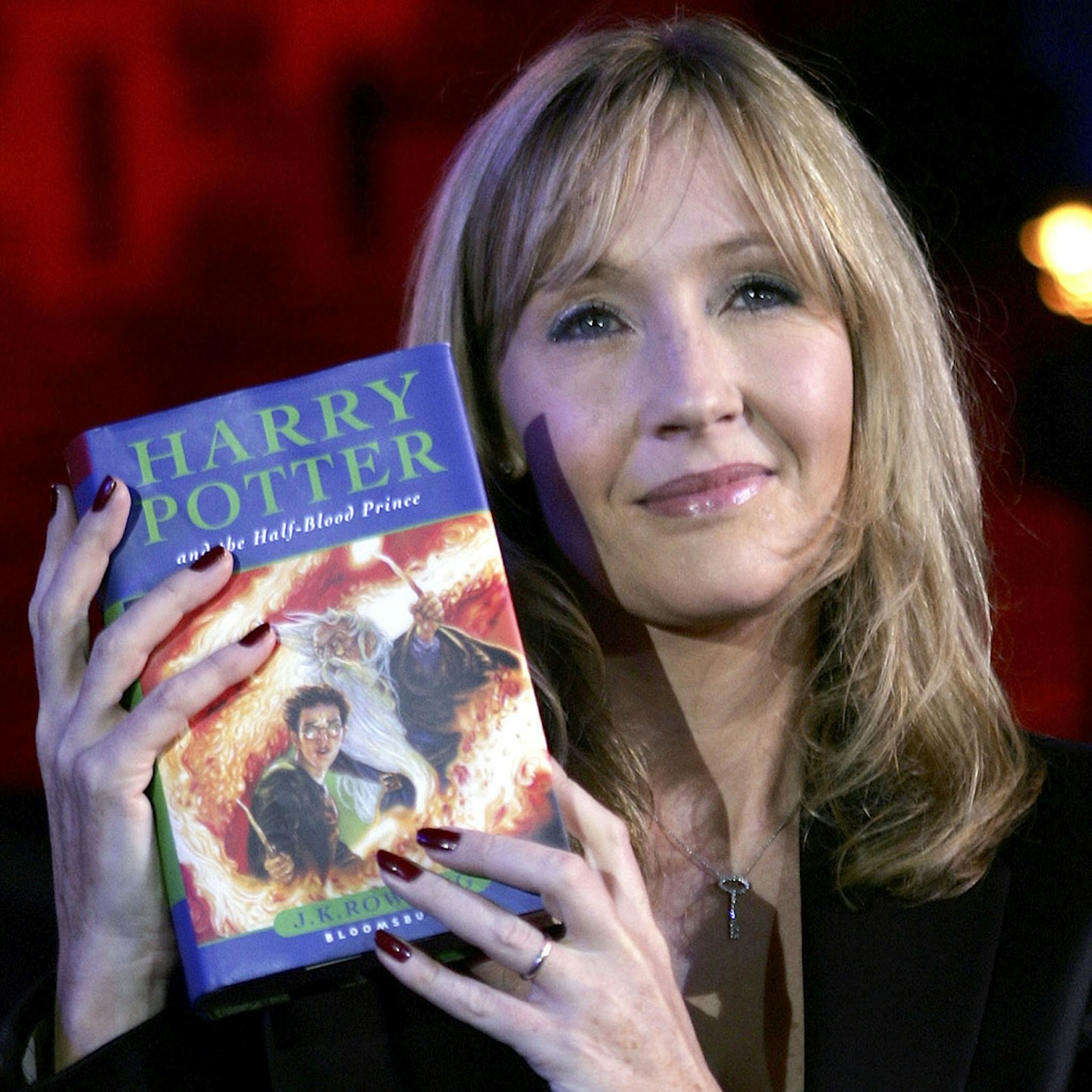 Author J.K. Rowling with her sixth book, Harry Potter and the Half-Blood Prince