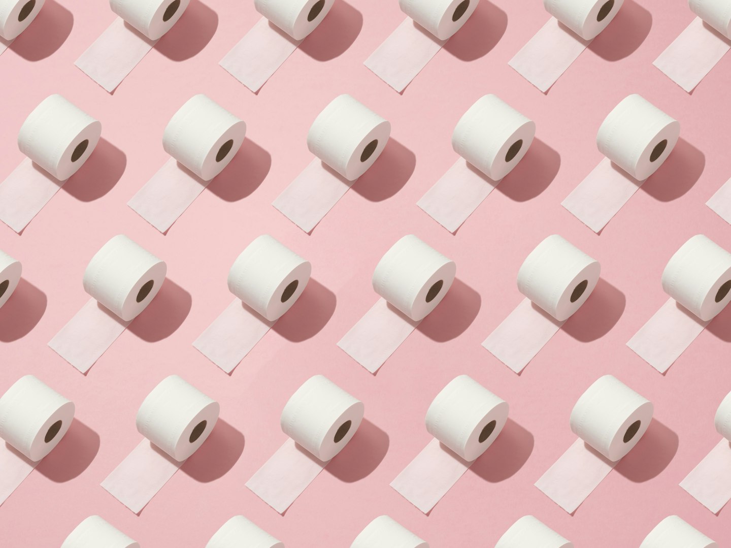 Toilet rolls on pink background