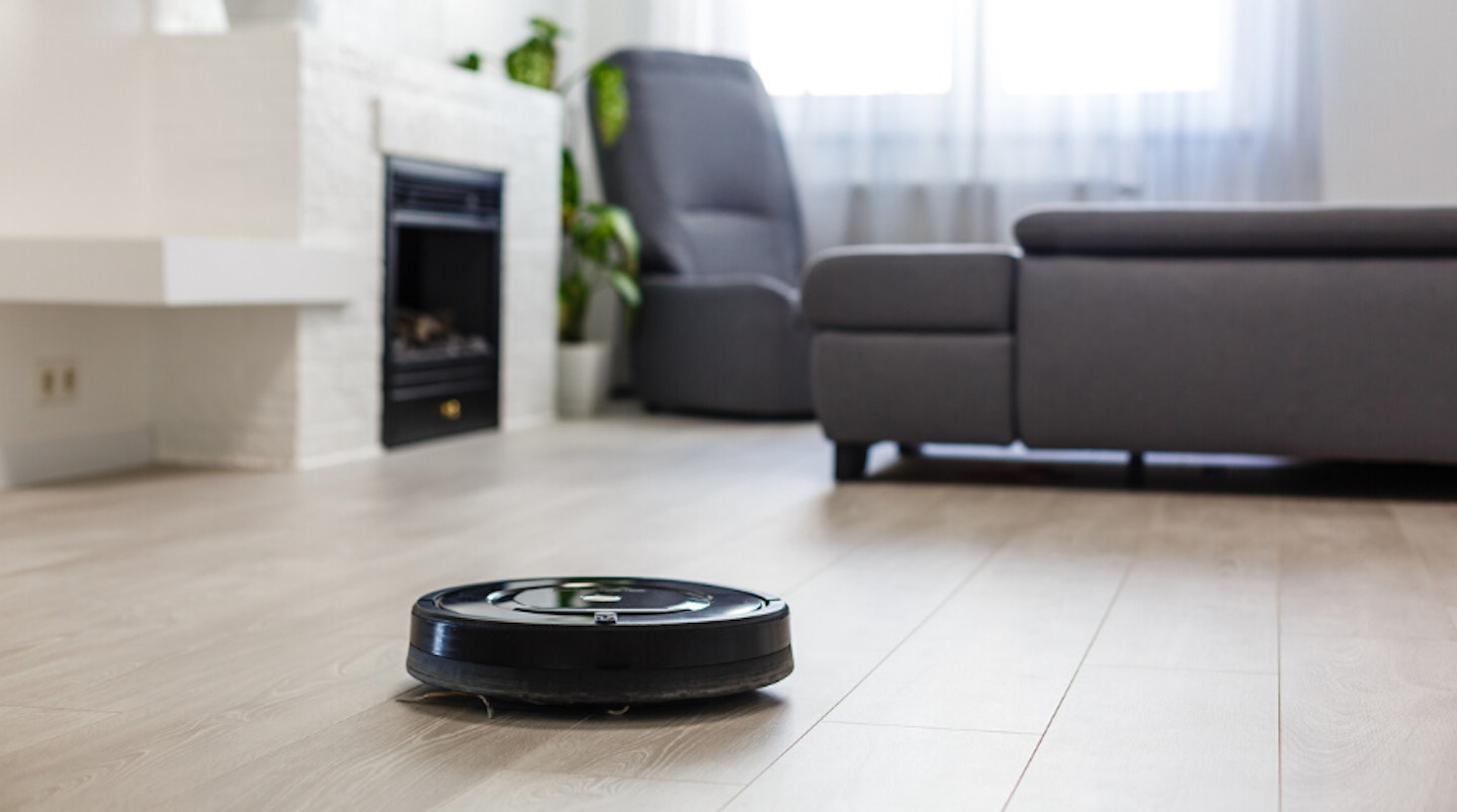 Automatic vacuum cleaner on living room floor