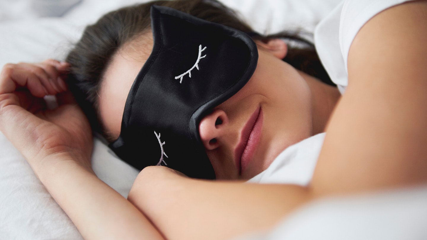 Woman sleeping with sleep mask on