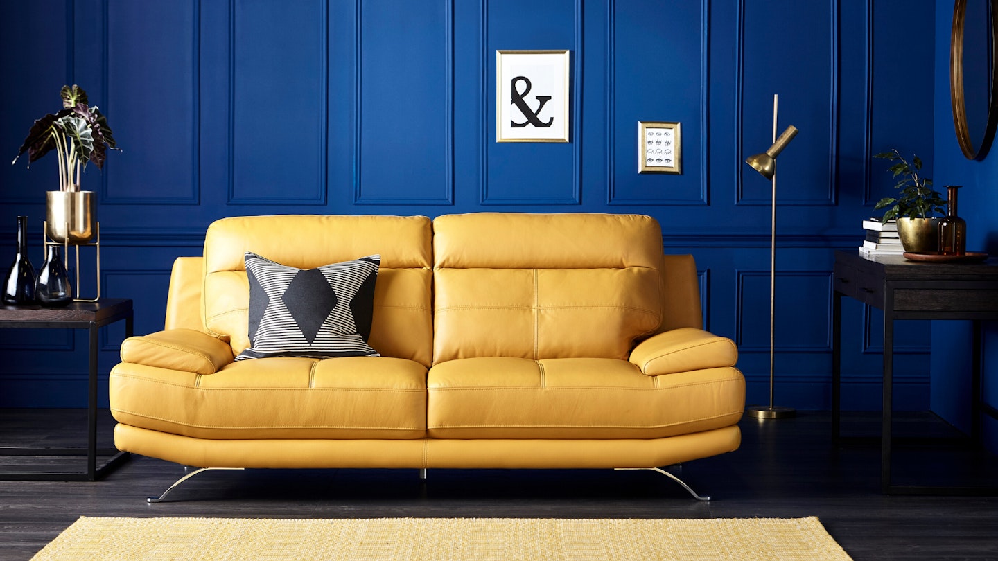 Yellow sofa in classic blue room