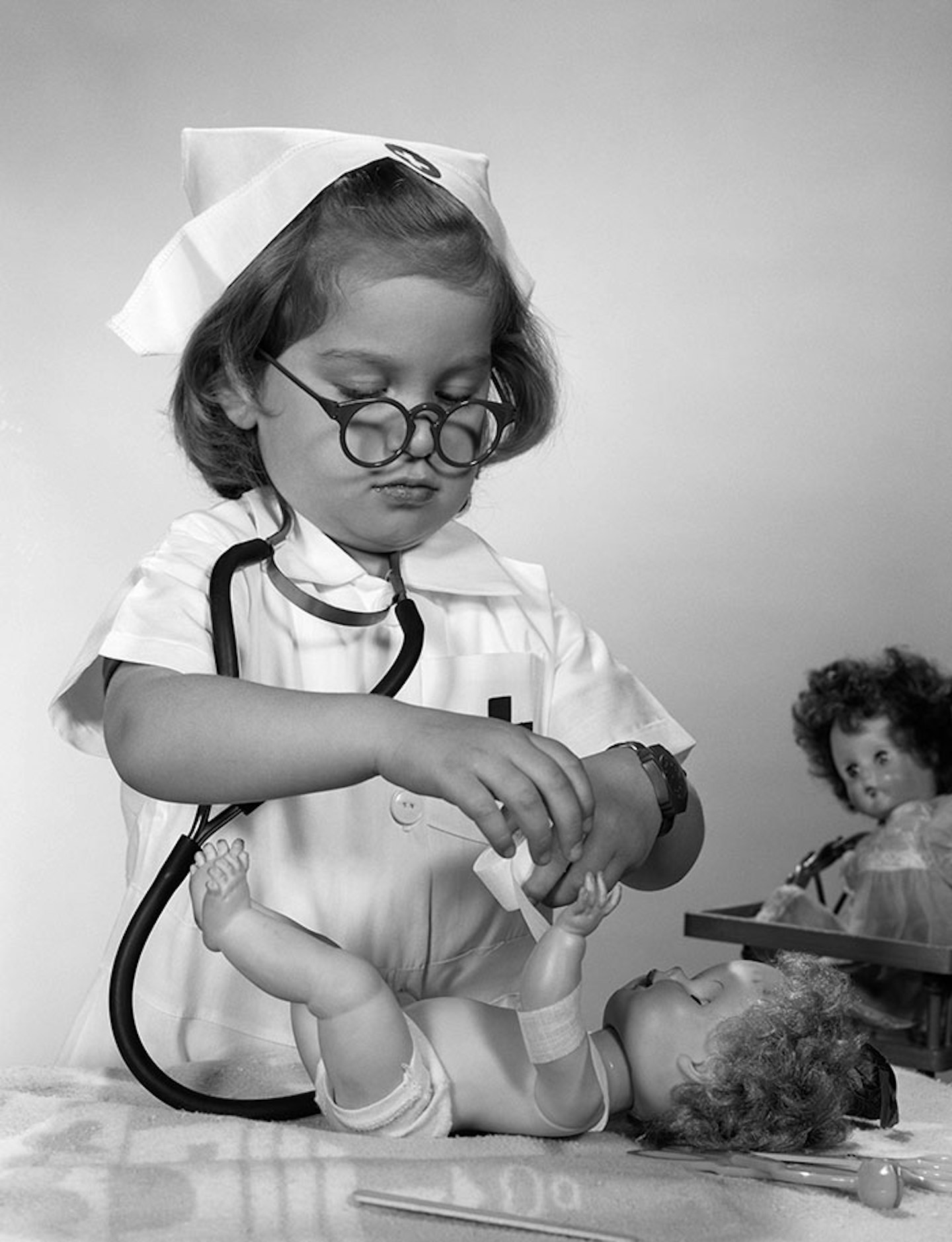 child playing nurse to dolls